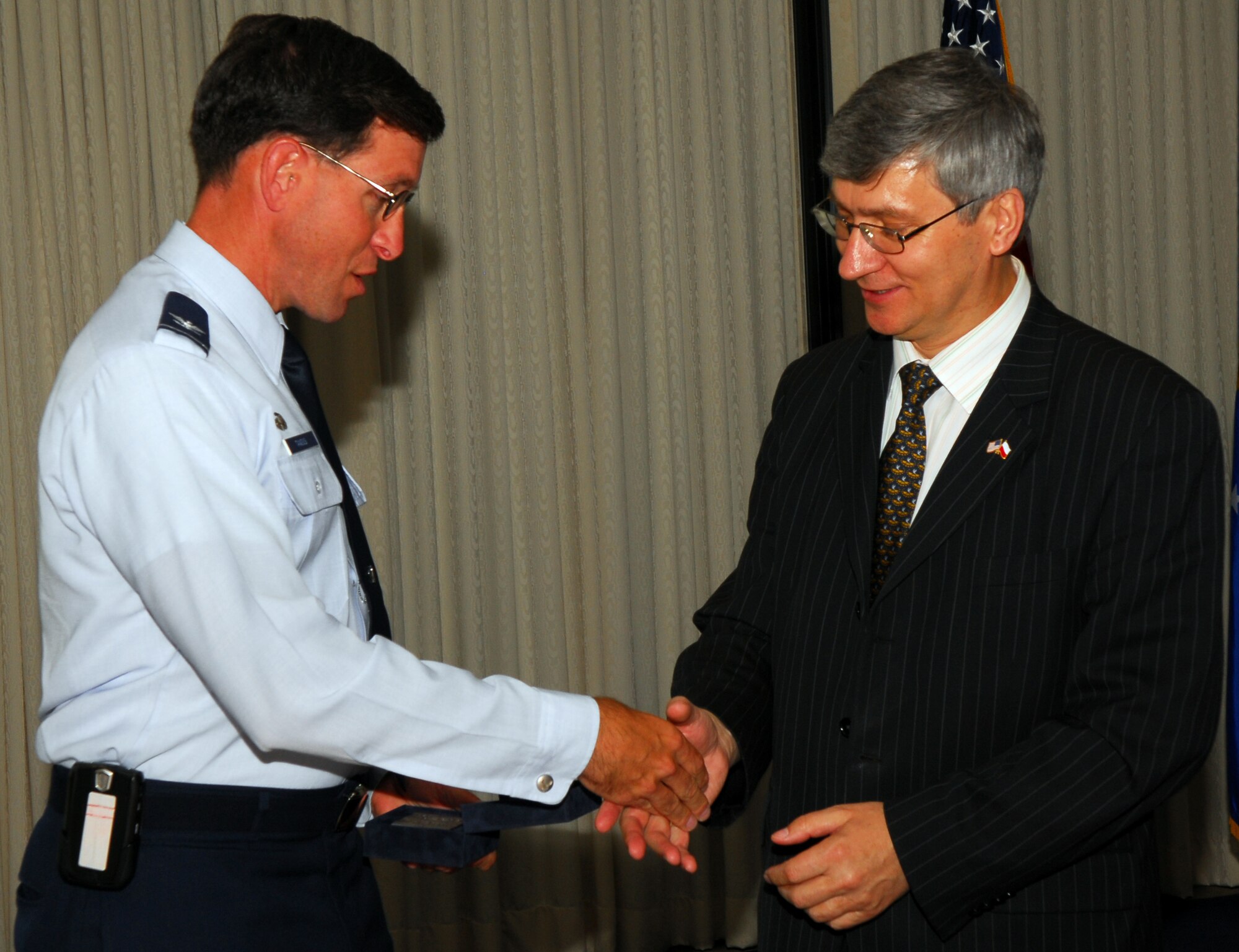 VANDENBERG AIR FORCE BASE, Calif. -- Col. Steve Tanous, 30th Space Wing commander, exchanges coins with Republic of Poland Senator Franciszek Adamczyk at the Pacific Coast Club on June 29.  Three senators of the Republic of Poland visited the base as part of the U.S. State Department's International Visitor Leadership Program.  (U.S. Air Force photo/Airman 1st Class Robert Lewis)