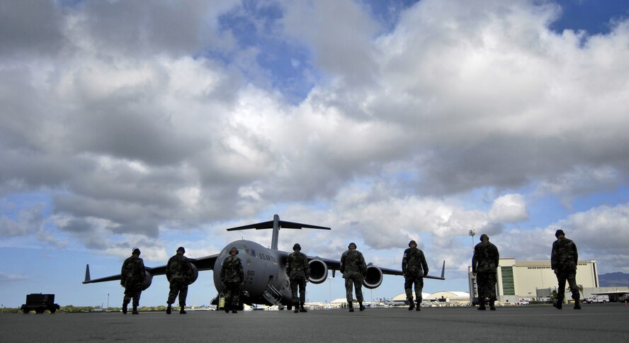 HICKAM AIR FORCE BASE, Hawaii -- Crew chiefs conduct a foreign object debris (FOD) walk June 28 before launching a C-17 Globemaster III. The Airmen, from the 15th Aircraft Maintenance Squadron, are practicing for the upcoming Air Mobility Command Rodeo at McChord Air Force Base, Wash. (U.S. Air Force photo/ Tech. Sgt. Shane A. Cuomo)