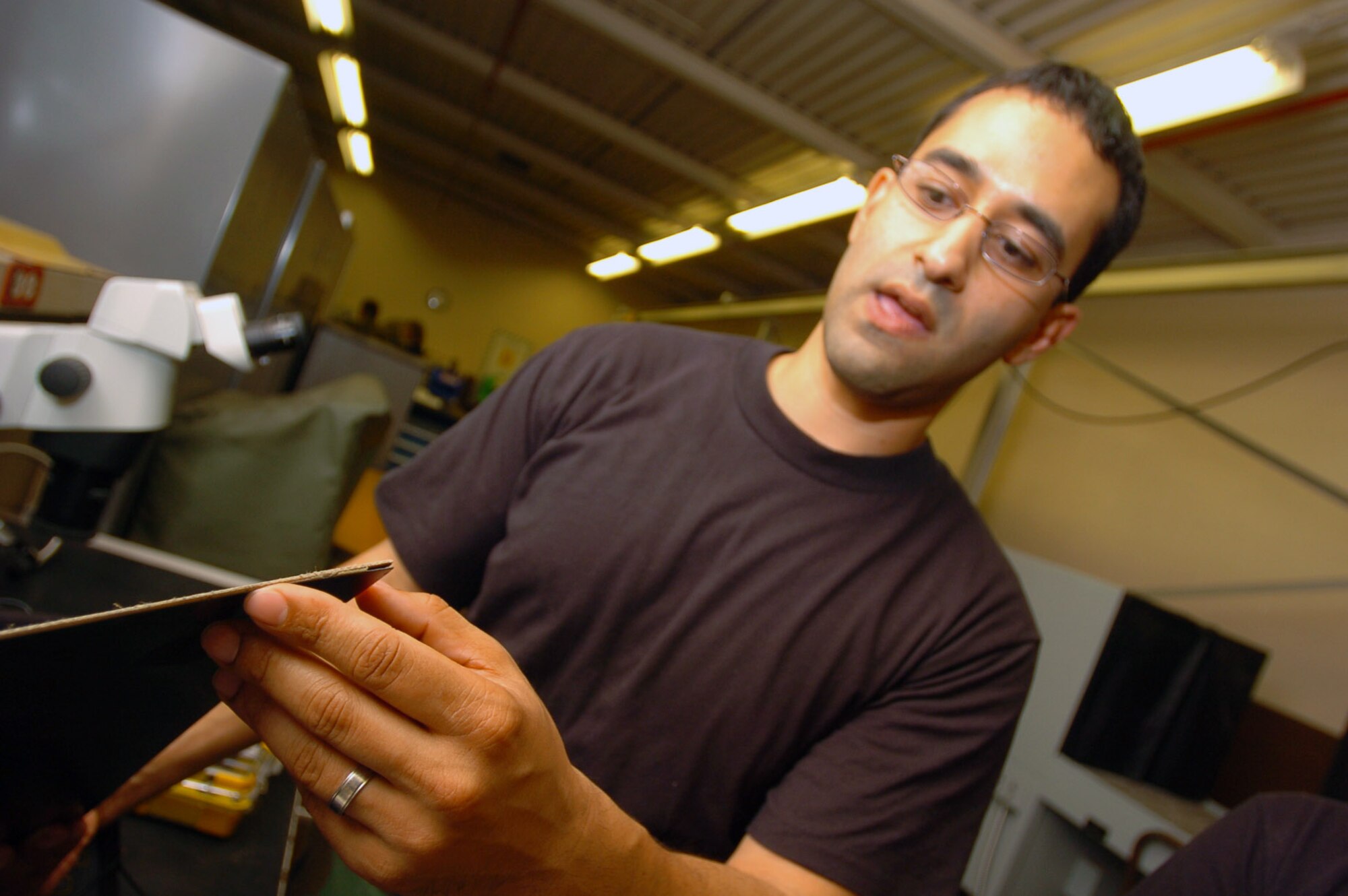 Tech. Sgt. Antonio Mercado, a reservist from McChord Air Force Base, Wash., shows an example of the damage the sonogram can detect that can't be seen by looking at the aircraft at Hickam Air Force Base, Hawaii. (U.S. Air Force photo/Angela Elbern)
