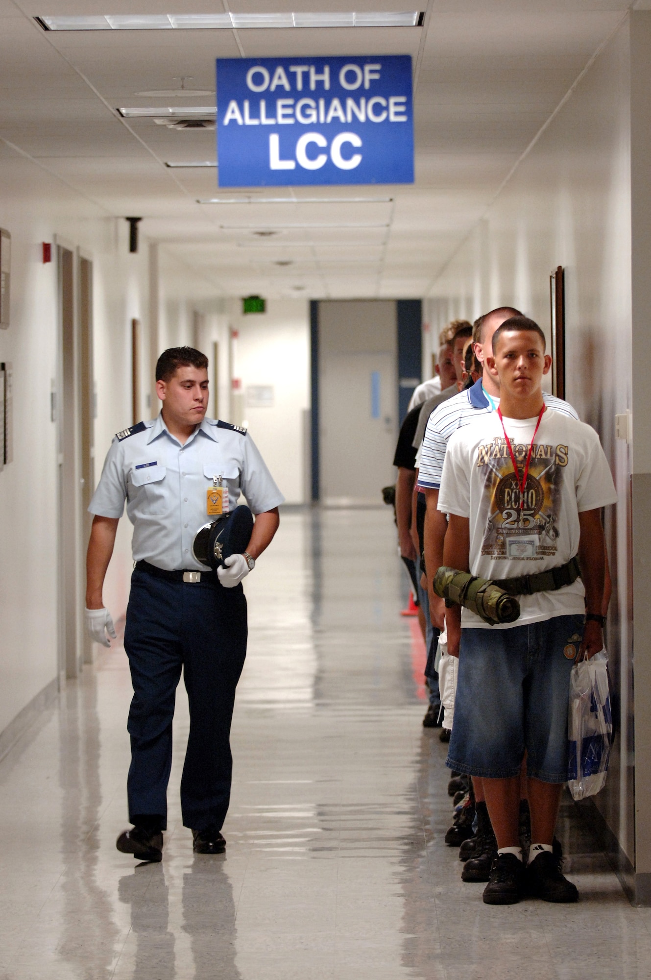 Cadet 1st Class Nicholas Lee provides motivational training as basic cadet trainee's form up to recieve the Oath of Allegiance during inprocessing of the Class of 2011 June 28 at the U.S. Air Force Academy in Colorado. The 1,304 members arrived June 28 to begin basic cadet training. (U.S. Air Force photo/Mike Kaplan) 
