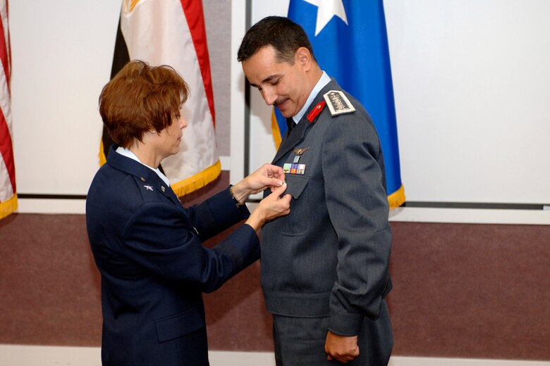 Brig. Gen. Kathleen Close, Ogden Air Logistics Center commander, pins a symbolic star on the pocket of recent promotee Brig. Gen. Hesham Ahmed, Egyptian Air Force international liaison officer, June 28. General Ahmed's duties on Hill Air Force Base include the management of EAF F-16 Fighting Falcons and F-4 Phantoms. (U.S. Air Force photo by Alex R. Lloyd)