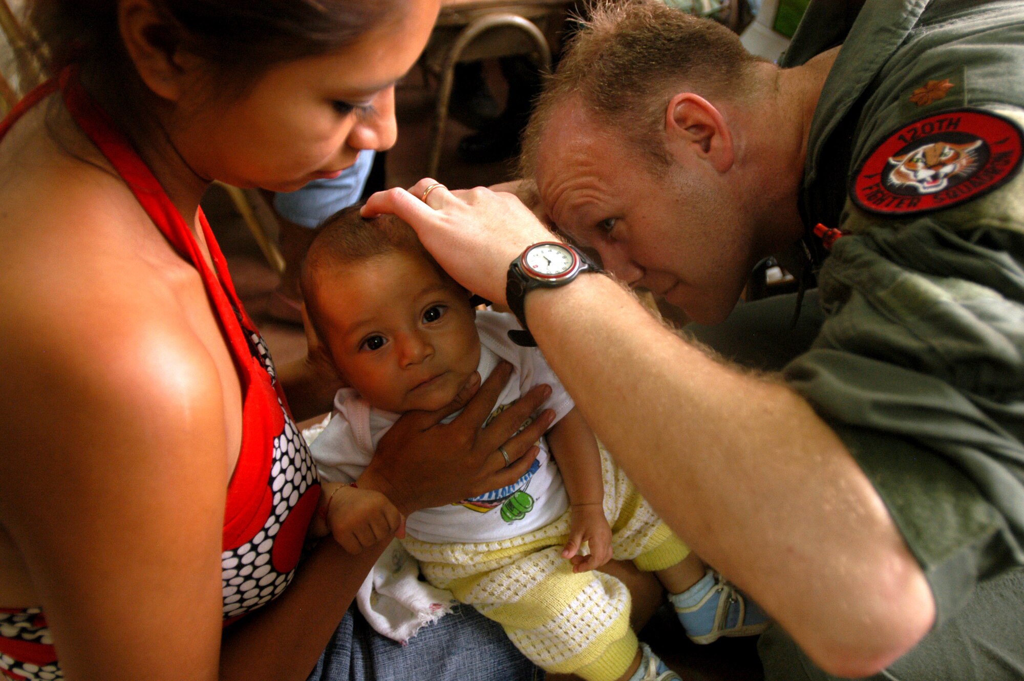 Maj. (Dr.) Rich Hendershot examines an infant during a visit to an El Salvadorian clinic June 14. Maj. Hendershot and other Airmen assigned to the Colorado Air National Guard's 140th Medical Group were deployed to Sonsonate, El Salvador, for 10 days.  (U.S. Air Force photo/1st Lt. Darin Overstreet)
