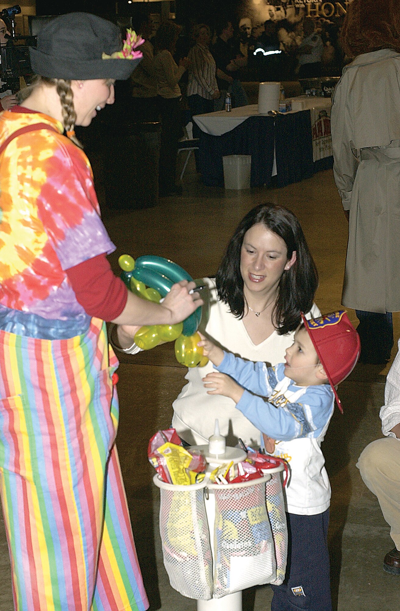 Lea Belle, left, hands Tyler Booth a turtle balloon she made for him as his mother, Tech. Sgt. Andi Booth, watches during the Heroes Welcoming Heroes event March 8 at the National Museum of the U.S. Air Force. The base and local organizations host this party for military people who return from deployments. The next event is planned for 6-8 p.m. July 11 at the National Museum of the U.S. Air Force. (U.S. Air Force photo/Spencer P. Lane)
