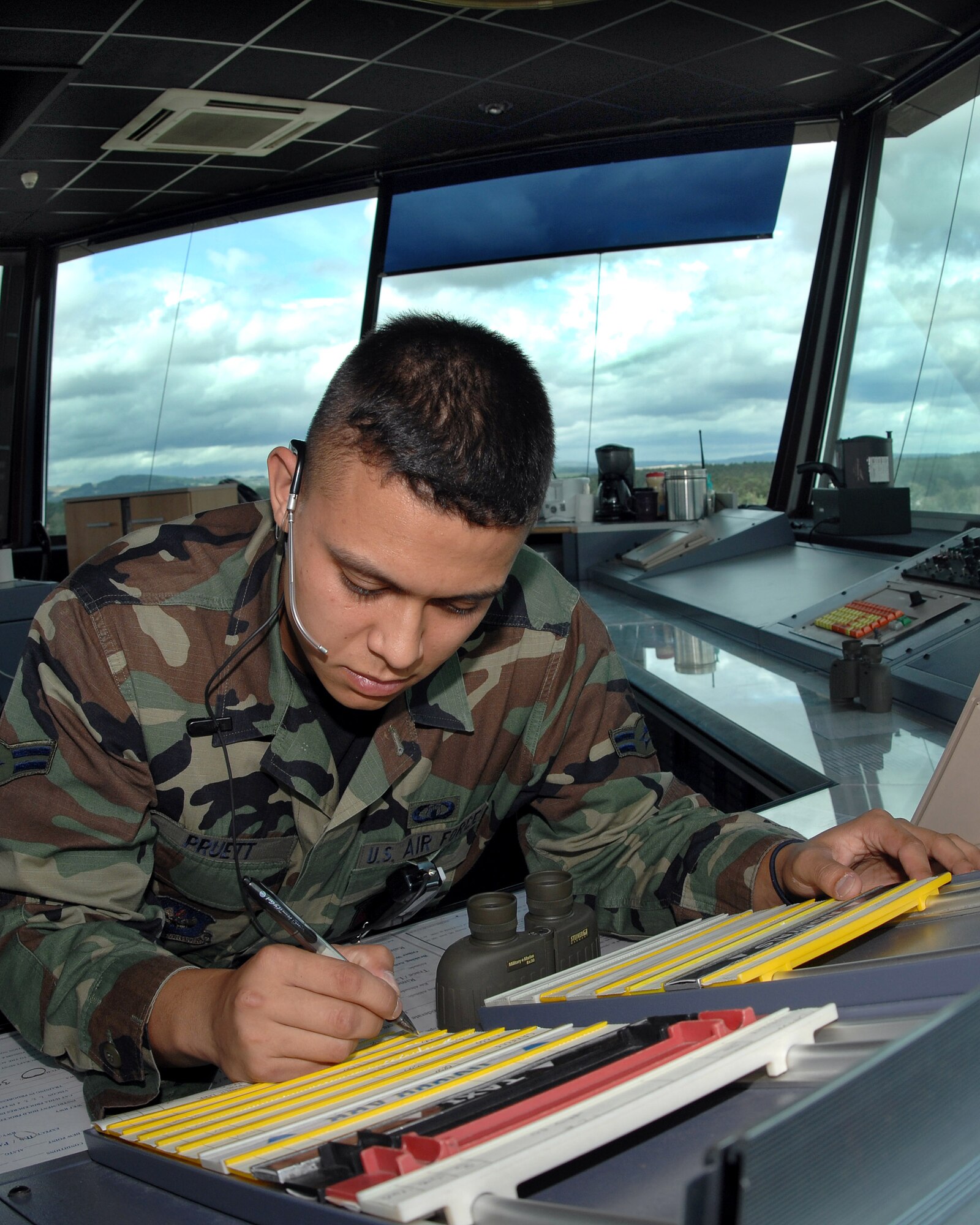 Airman 1st Class Earl Pruett writes coordinates of an inbound aircraft on a flight progress strip June 26 in the control tower at Ramstein Air Base, Germany. Airman Pruett is a flightline local coordinator assigned to the 86th Operations Support Squadron. (U.S. Air Force photo/Airman 1st Class Kenny Holston)
