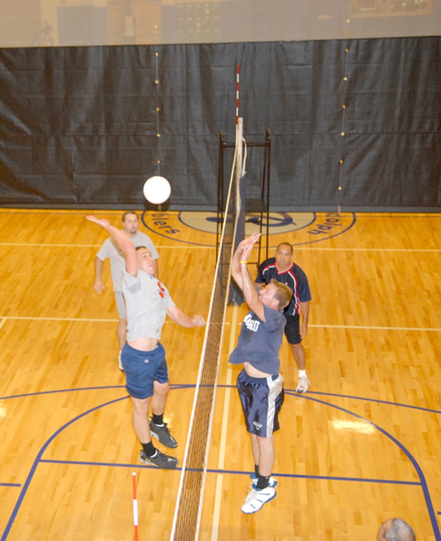 Kirk Remer, 12th Communications Squadron, jumps to hit the ball past Air Education and Training Command’s Chris Powell during the base intramural volleyball championship June 21. (U.S. Air Force photo by Rich McFadden)