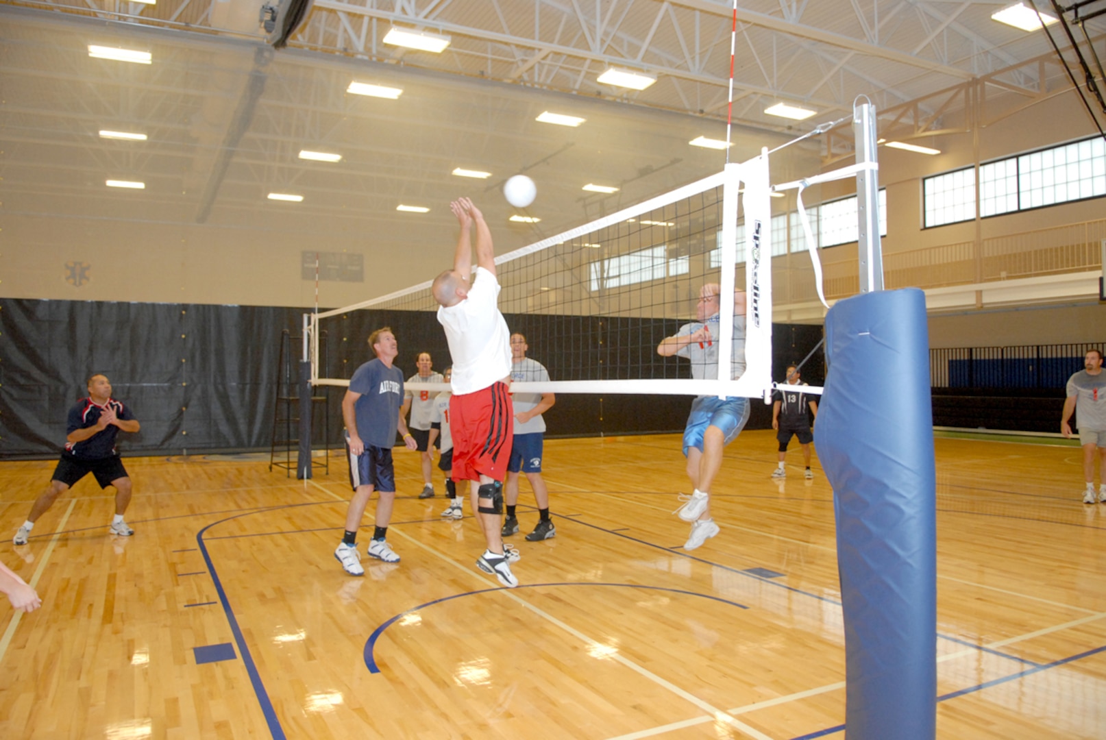 Air Education and Training Command’s Mark Baer blocks a shot at the net against the 12th Communications Squadron during the intramural volleyball championship June 21. (U.S. Air Force photo by Rich McFadden)