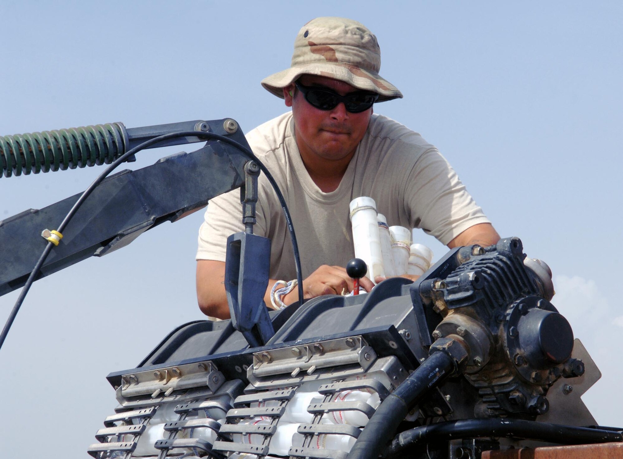 An ammo Airman with the 455th Expeditionary Aircraft Maintenance Squadron prepares to download rounds from the nose gun of an A-10 at Bagram Airfield, Afghanistan. (U.S. Air Force photo by Staff Sgt. Craig Seals)