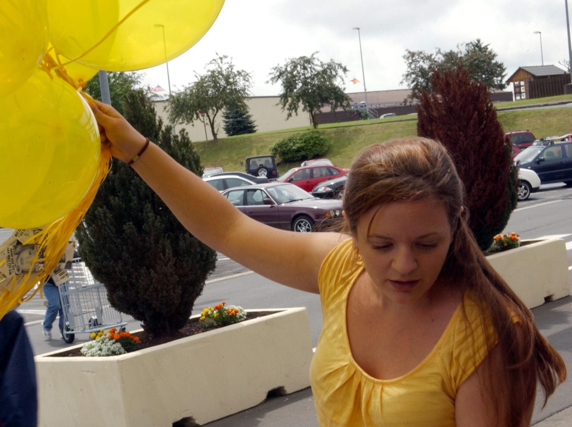 SPANGDAHLEM AIR BASE, Germany -- Sarah Crider helps prepare 50 balloons for release June 22 with “Look for Madeleine” cards attached to them. The date marked 50 days since young Madeleine McCann went missing. People from all over the world held similar events to show their support for Madeleine’s family. (US Air Force photo/Airman 1st Class Allen Pollard)                              