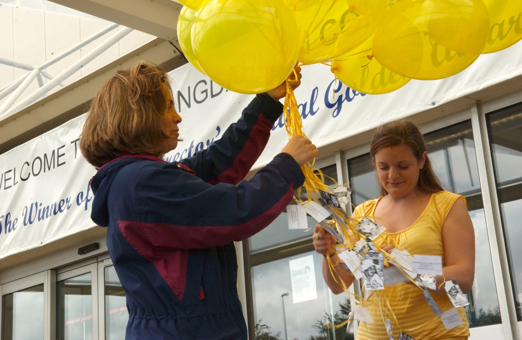 SPANGDAHLEM AIR BASE, Germany -- Christine Bennett (left) and Sarah Crider prepared and released 50 balloons June 22 with “Look for Madeleine” cards attached to them. The date marked 50 days since young Madeleine McCann went missing. People from all over the world held similar events to show their support for Madeleine’s family. (US Air Force photo/Airman 1st Class Allen Pollard)                              