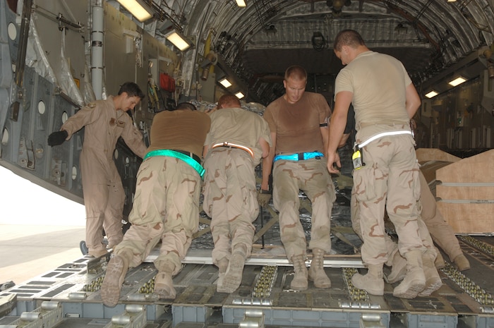 Airmen with the 816th Expeditionary Airlift Squadron load a pallet of cargo onto a C-17. Units all over base have increased the operations tempo in the last few months to help support the recent surge of servicemembers into the Operation Iraqi Freedom area of responsibility. (U.S. Air Force photo by Master Sgt. Ken Stephens)