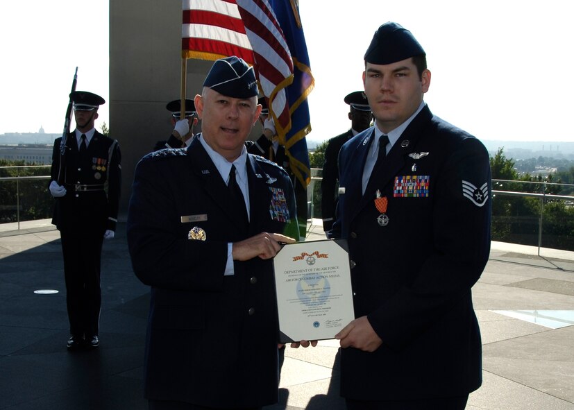 Staff Sgt. Daniel Paxton, right, an aeromedical evacuation instructor assigned to Brooks was among the first to receive the new Air Force Combat Action Medal in a ceremony presided over by Air Force Chief of Staff Gen. T. Michael Moseley, at the Air Force Memorial June 13. (Courtesy photo)	