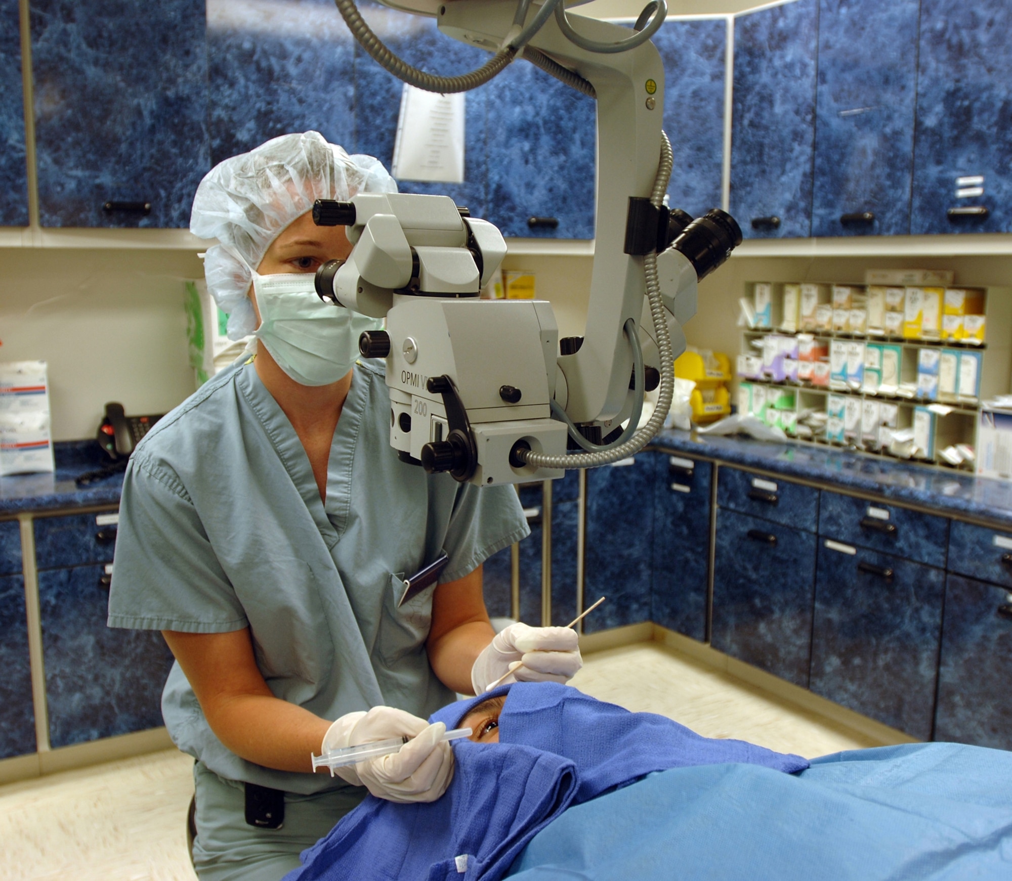 Second-year Ophthalmology resident Capt. (Dr.) Kristine Pierce, 59th Training Support Squadron, removes a foreign object from a patient's eye. (U.S. Air Force photo by Master Sgt. Kimberly A. Yearyean-Siers)