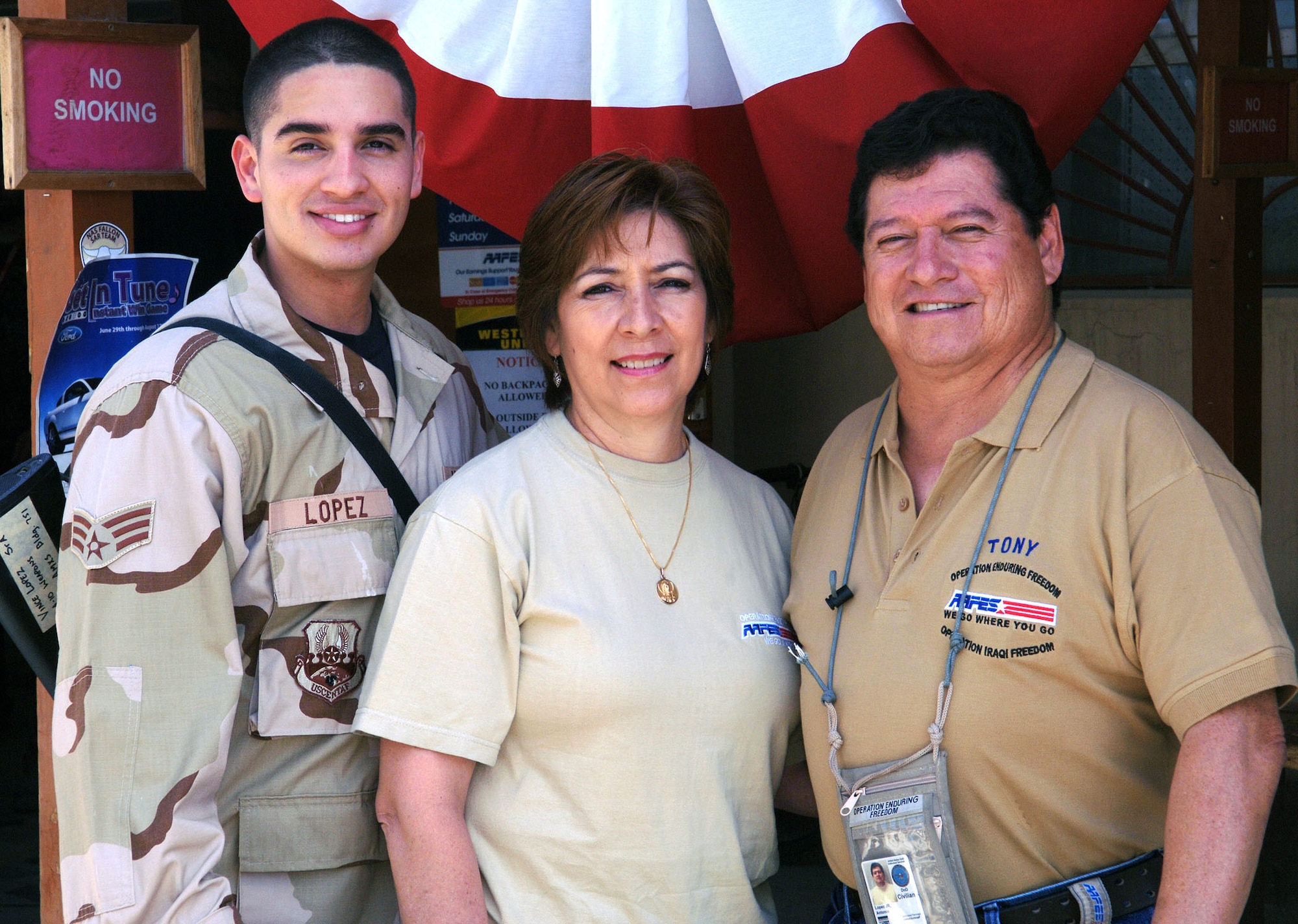(From left to right) Senior Airman Vincent Lopez, stepmother Julia Lopez and father Tony Lopez. Airman Lopez is an A-10 weapons loader assigned to the 354th Expeditionary Aircraft Maintenance Unit deployed from Davis-Monthan Air Force Base, Ariz. The Lopez family are all deployed to Bagram together. (U.S. Air Force photo by Staff Sgt. Craig Seals)