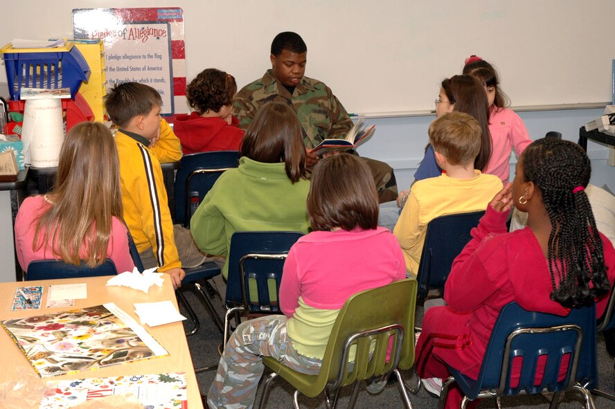 OSAN AIR BASE, Republic of Korea --  Senior Airman Demetriance Johnson reads "Buster," a children's book, to Mr. Roger Saunder's 3rd grade class at Osan American Elementary School Friday. He was reading as part of the 10th Annual "Read Across America" Day, which is sponsored by the National Education Association and is in honor of children's author Dr. Seuss' birthday. Airman Johnson is with the 51st Aeromedical Dental Squadron. (U.S. Air Force photo by Staff Sgt. Benjamin Rojek)