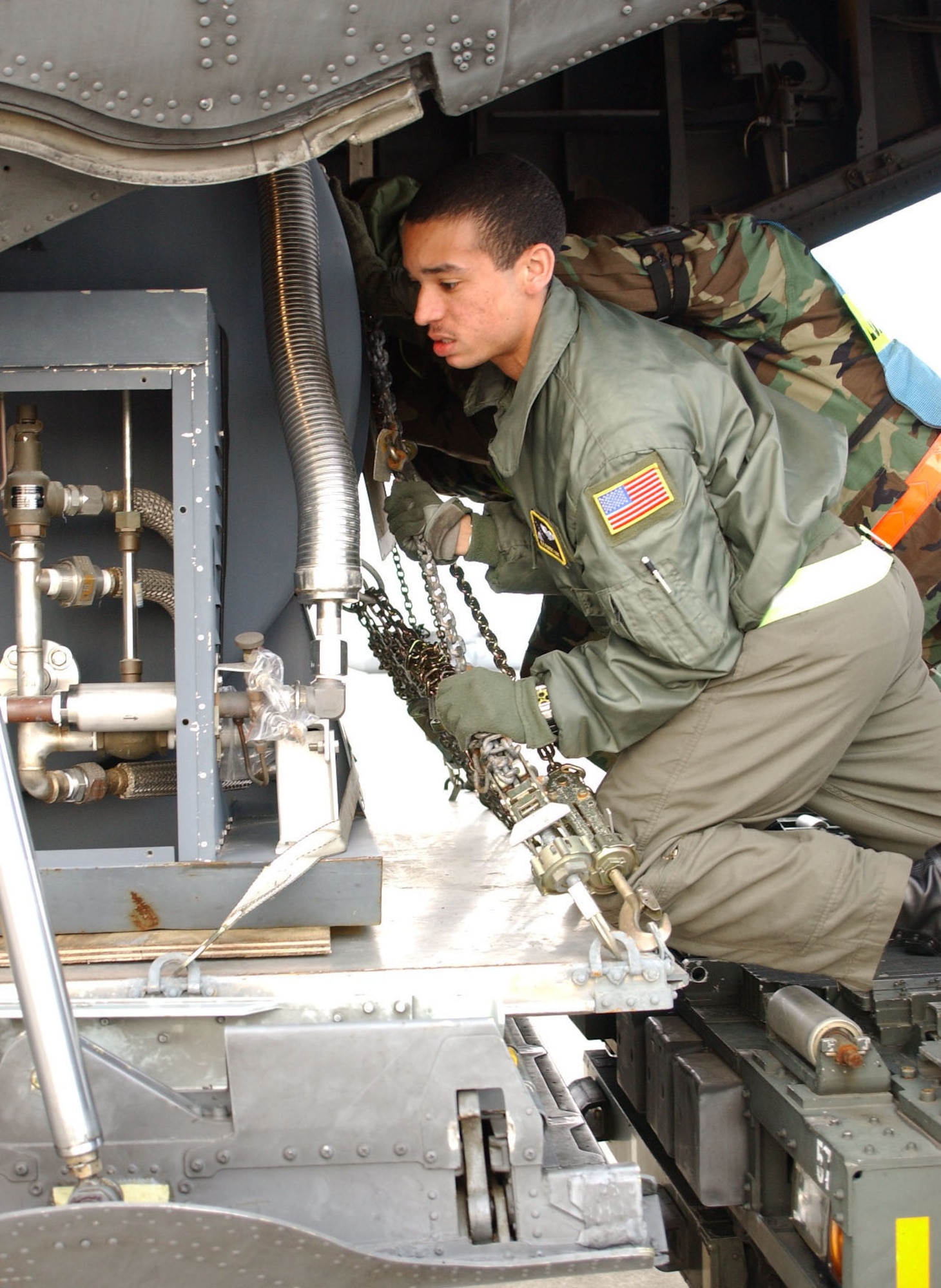 YOKOTA AIR BASE, Japan -- Airman 1st Class Robert Gore, 36th Airlift Squadron, and Airmen from the 374th Maintenance Squadron push a tank onto a C-130
Hercules during the base's last Initial Response Readiness Exercise. The
374th Airlift Wing will begin the PACAF IRRI this week. (U.S. Air Force photo by Airman 1st Class Jonathan M. Fowler)                              
