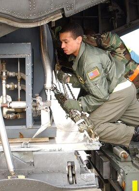YOKOTA AIR BASE, Japan -- Airman 1st Class Robert Gore, 36th Airlift Squadron, and Airmen from the 374th Maintenance Squadron push a tank onto a C-130
Hercules during the base's last Initial Response Readiness Exercise. The
374th Airlift Wing will begin the PACAF IRRI this week. (U.S. Air Force photo by Airman 1st Class Jonathan M. Fowler)                              