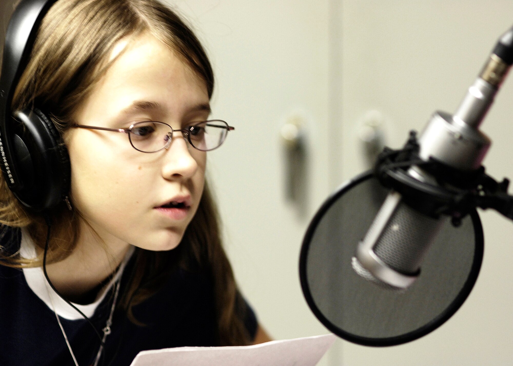FAIRCHILD AIR FORCE BASE, Wash. -- Faith Micklich, daughter of Tech. Sgt. Brian Micklich, 92nd Aircraft Maintenance Squadron reads a poem about love and depression Feb. 11 over the 92.3 FM airwaves. Faith participated in the Spokane Open Poetry Radio Program with nine other schoolmates from Michael Anderson Elementary School at Fairchild. (Photo by Senior Airman Anthony Ennamorato)
