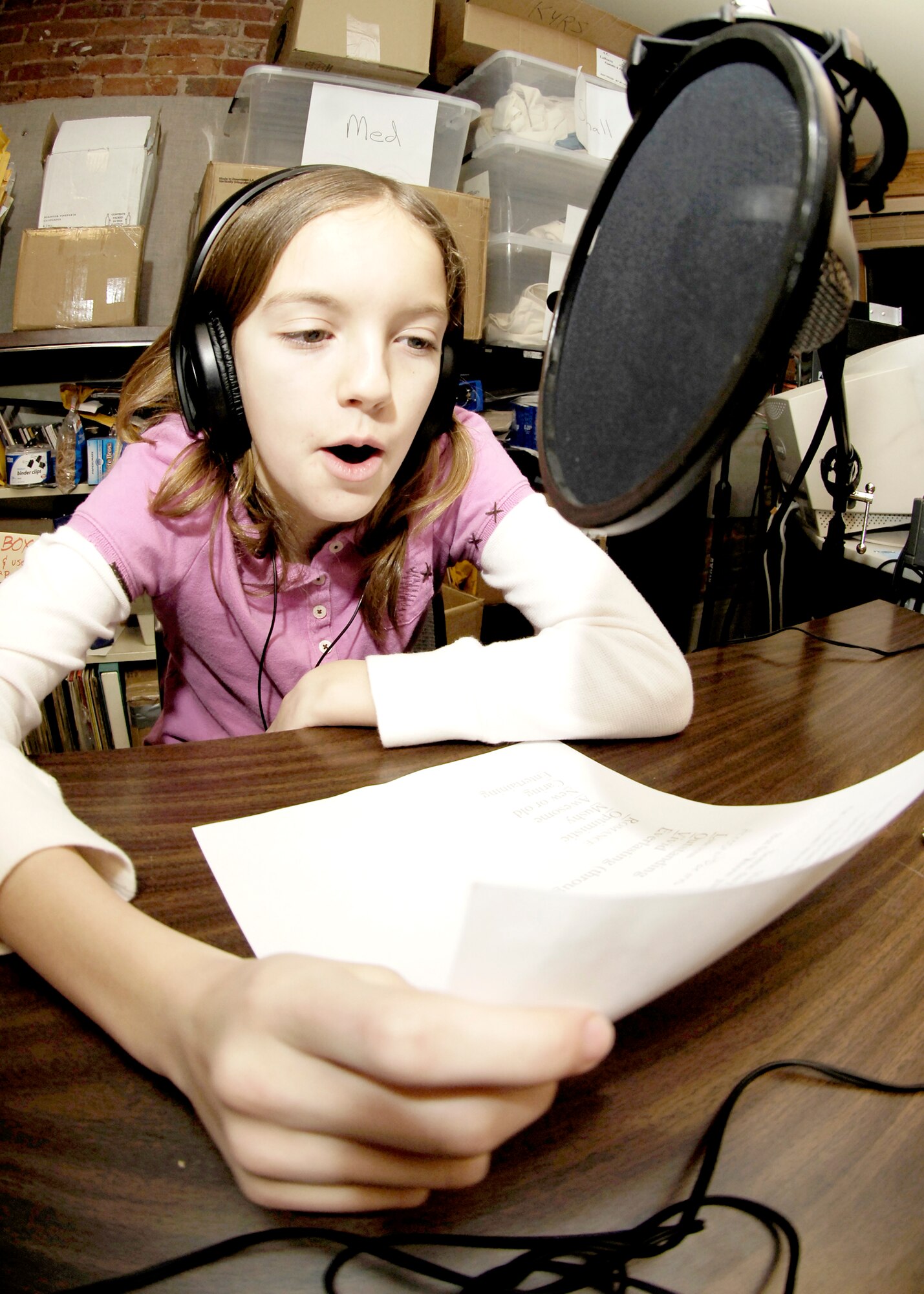 FAIRCHILD AIR FORCE BASE, Wash. -- Morgan Holmes, daughter of Tech. Sgt. William Holmes, Joint Personnel Recovery Agency, reads a poem about what love means to her on Feb. 11. Ten students from Fairchild’s Michael Anderson Elementary School read their poems about love and Valentine’s Day on 92.3 FM during the Spokane Open Poetry Radio Program. (Photo by Senior Airman Anthony Ennamorato)
