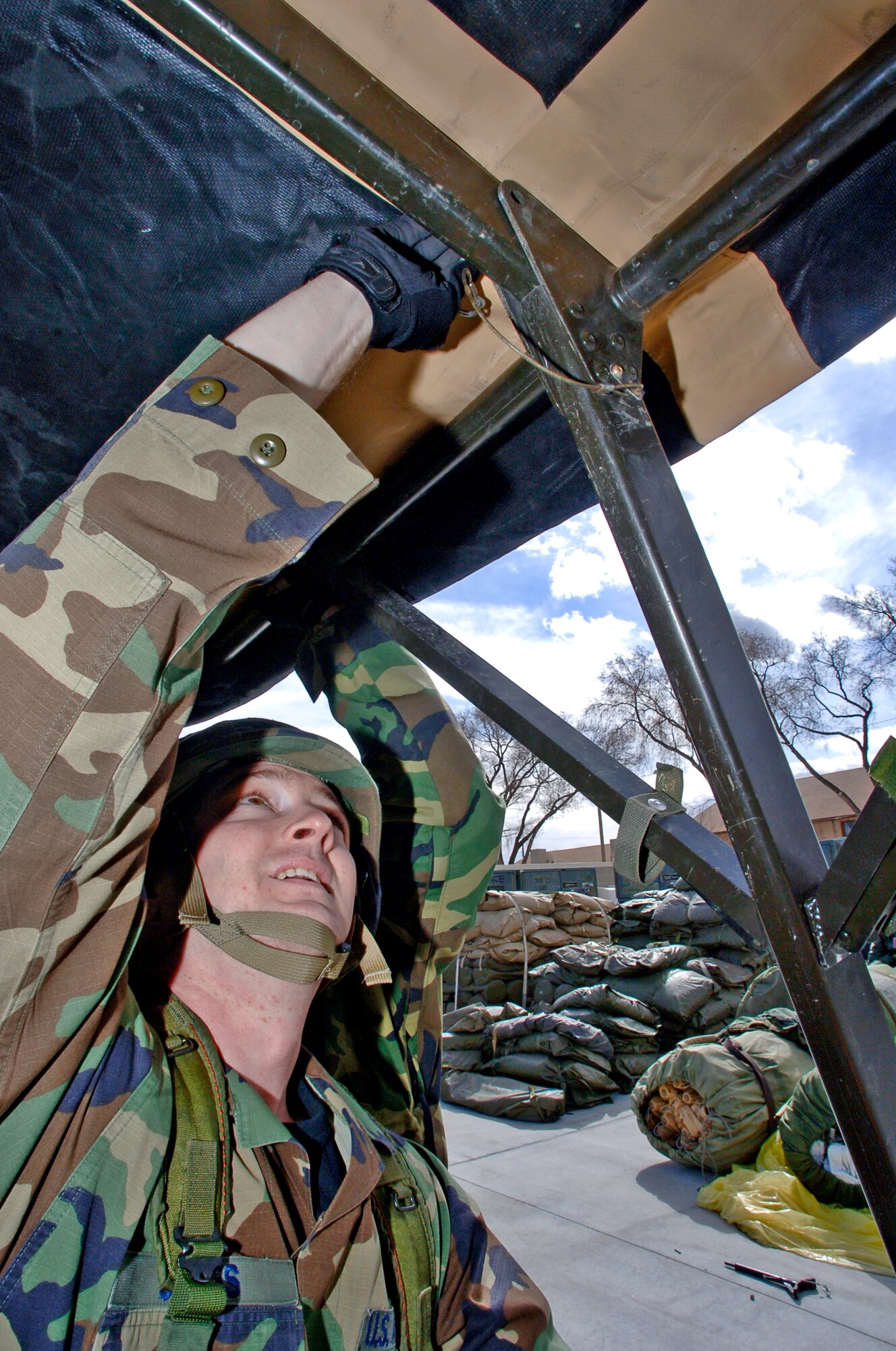 MOUNTAIN HOME AIR FORCE BASE, Idaho -- Staff Sgt Jerid Jones, 366th Communications Squadron, inserts a pin into the frame to secure a tent in place while helping set up a tent city at a simulated deployed location during the base’s Sharpshooter exercise here Feb. 28. The week-long exercise tested the 366th Fighter Wing’s ability to deploy to an overseas location to conduct combat operations from this austere location. Air Force photo by Airman 1st Class Ryan Crane
