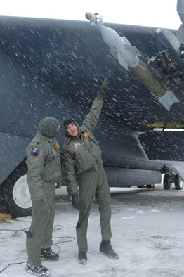 MINOT AIR FORCE BASE, N.D. – Lt. Col. Paul Von Osterheldt (left) and Capt. Dennis Cummings, both from the 23rd Bomb Squadron, discuss the payload attached to a B-52H Stratofortress before a scheduled flight Feb. 28, 2007. Snow fall accumulation delayed the flight until March. 1. The crew will fly to the Marine Corps Air Ground Combat Center 29 Palms, Calif. to test the bomb. (U.S. Air Force photo by Senior Airman Christopher Boitz) 