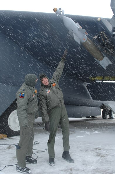 MINOT AIR FORCE BASE, N.D. – Lt. Col. Paul Von Osterheldt (left) and Capt. Dennis Cummings, both from the 23rd Bomb Squadron, discuss the payload attached to a B-52H Stratofortress before a scheduled flight Feb. 28, 2007. Snow fall accumulation delayed the flight until March. 1. The crew will fly to the Marine Corps Air Ground Combat Center 29 Palms, Calif. to test the missile.. (U.S. Air Force photo by Senior Airman Christopher Boitz)
