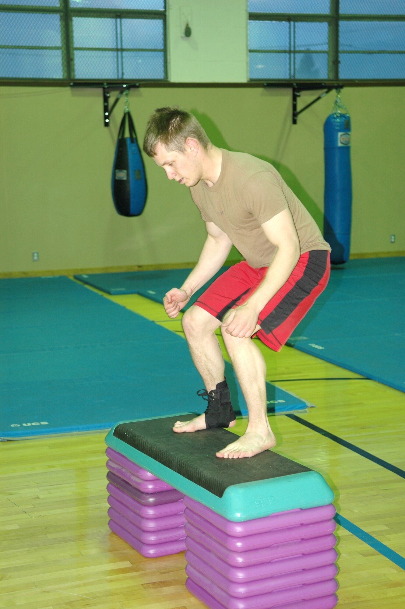 FAIRCHILD AIR FORCE BASE, Wash. -- Airman 1st Class Eddie Fore, a Survival, Evasion, Resistance and Escape specialist, completes 50 24-inch box jumps Wednesday before Mixed Martial Arts training at the SERE gym. The exercise is part of a warm-up routine called “the 300,” which also includes pull-ups, push-ups, Russian throws, windshield wipers and deadlifts. (Photo by Staff Sgt. Larry Carpenter)


