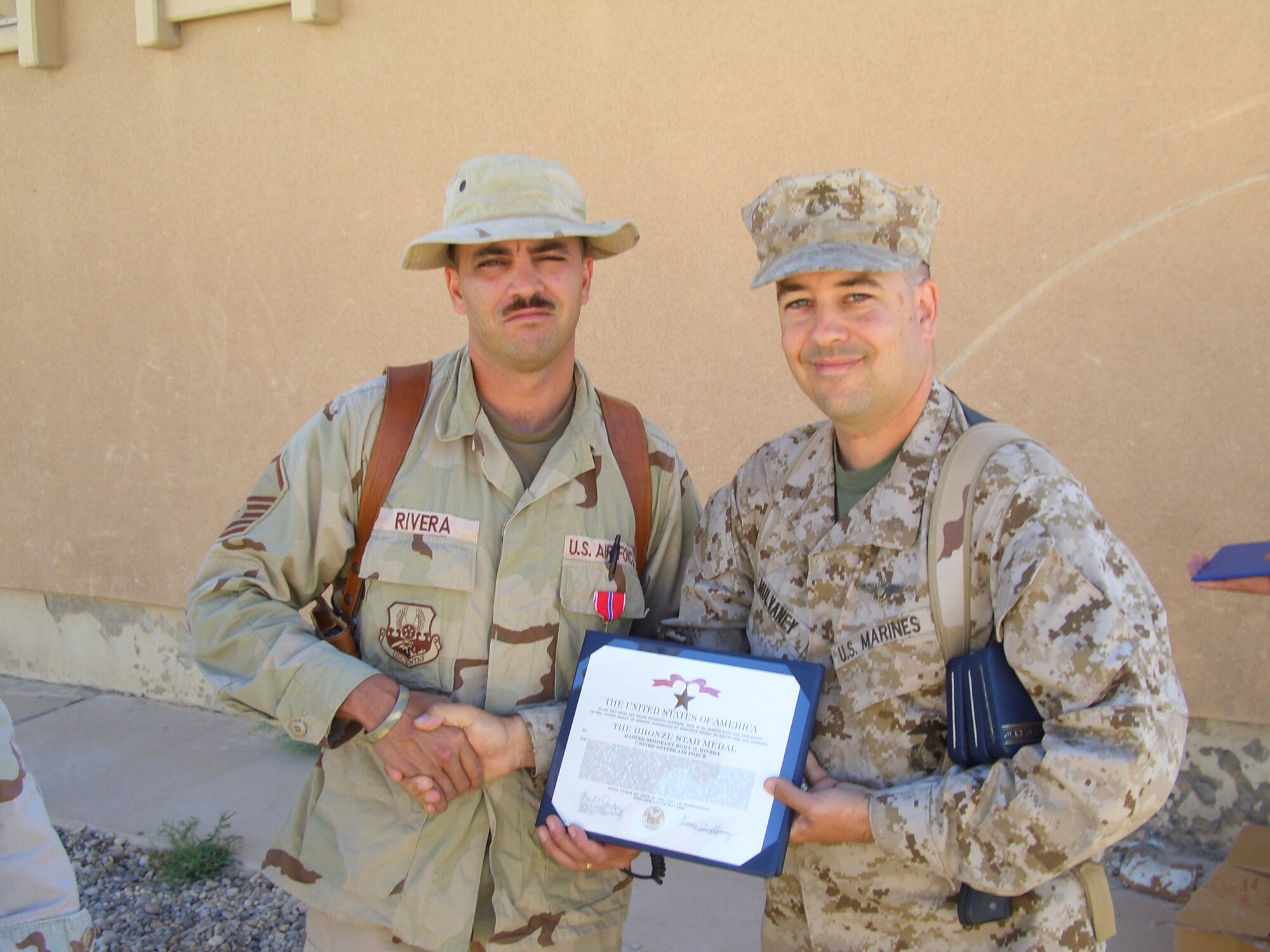 Master Sgt. Kory Rivera was awarded the Bronze Star by Marine Corps Maj. Branden Mulvaney, Regional Support Unit commander, at Al Asad, Iraq, at the end of his tour in June 2006. Sergeant Rivera said that he thinks what he did while deployed helped earn the Air Force Association "expeditionary medics" 2007 Team of the Year Award.  (Courtesy photo)
