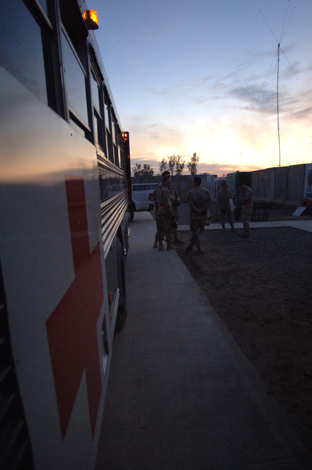 Contingency Aeromedical Staging Facility volunteers wait next to a medical transport bus for the sign to help load injured Sailors and Soldiers onto the bus that will take them to their flight Feb. 21 to Landstuhl, Germany, where they will receive further care for their wounds. The Contingency Aeromedical Staging Facility is a staging where patients are prepared for their flight out of Iraq. (U. S. Air Force photo/Staff Sgt. Michael R. Holzworth)