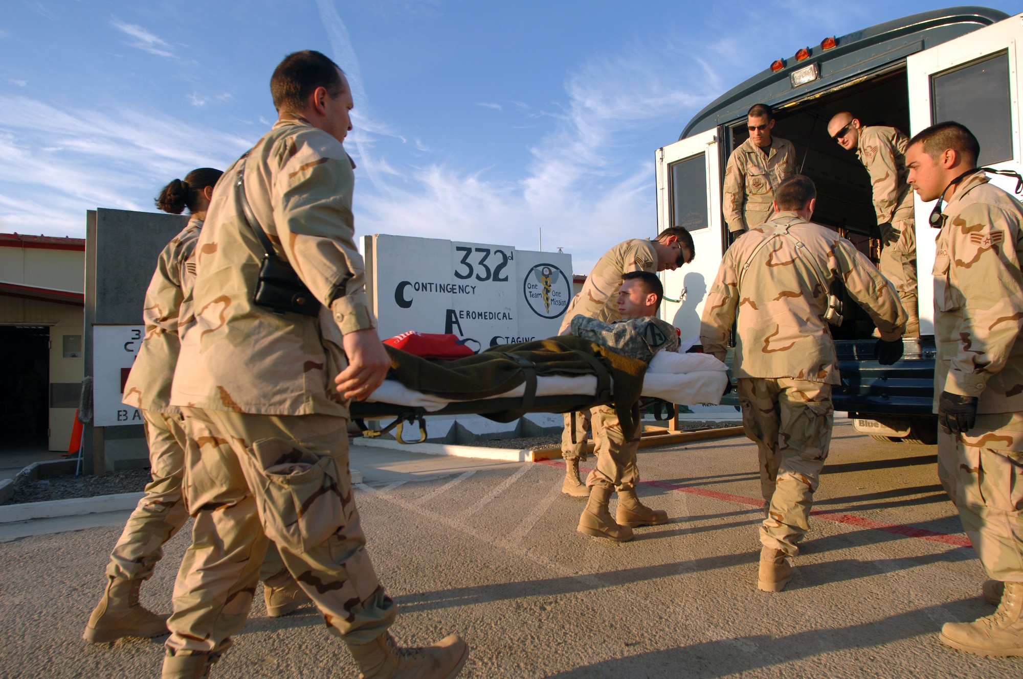 Airmen from the 332nd Air Expeditionary Wing volunteer at the Contingency Aeromedical Staging Facility to help load injured Soldiers onto a medical evacuation bus bound for the flightline Feb. 21 at Balad Air Base, Iraq. The Contingency Aeromedical Staging Facility is a staging where patients are prepared for their flight out of Iraq for further medical treatment at Landstuhl, Germany. (U. S. Air Force photo/Staff Sgt. Michael R. Holzworth) 
