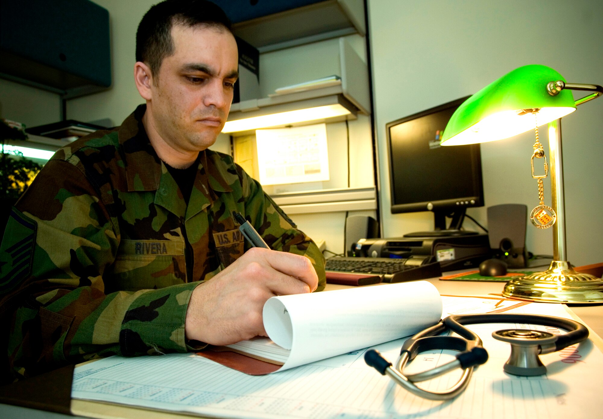 ELMENDORF AIR FORCE BASE, Alaska - Master Sgt. Kory Rivera reviews paperwork amidst overseeing the activities in his duty section. Sergeant Rivera is the NCOIC of the 3rd Medical Group Women's Health Services Flight. Sergeant Rivera was selected to receive the Air Force Association "expeditionary medics" 2007 Team of the Year Award and will represent the Pacific Air Force along with six other airmen at a ceremony in Washington D.C. April 3. (U.S. Air Force photo by Senior Airman Garrett Hothan)