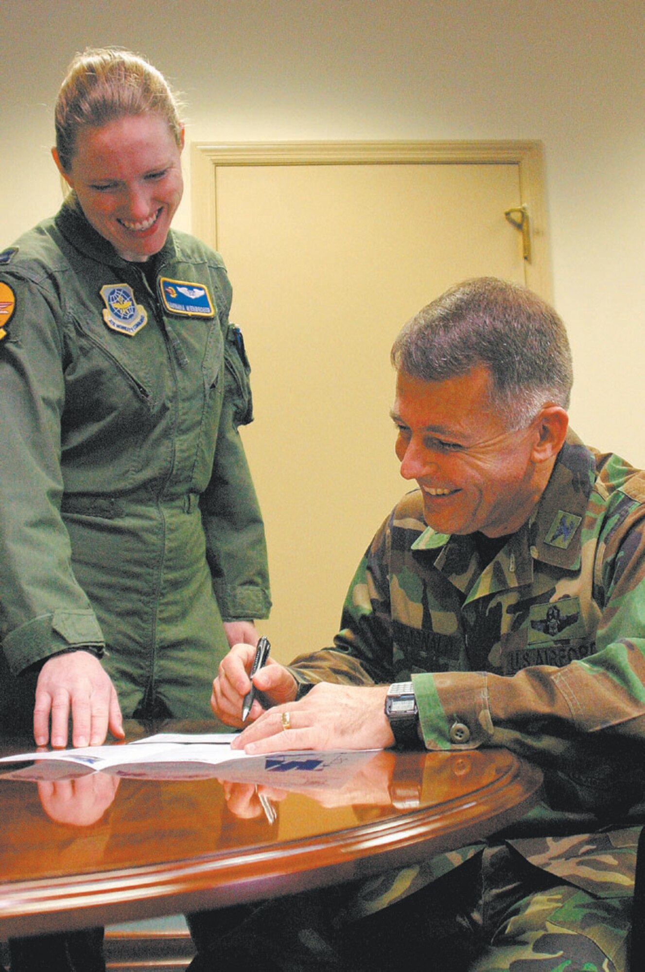 Col. John McDonald, 43rd Airlift Wing Vice Commander, coordinates with Air FOrce Assistance Fund project officer, Capt. Maryanna Wienbroeer, in his office Tuesday.