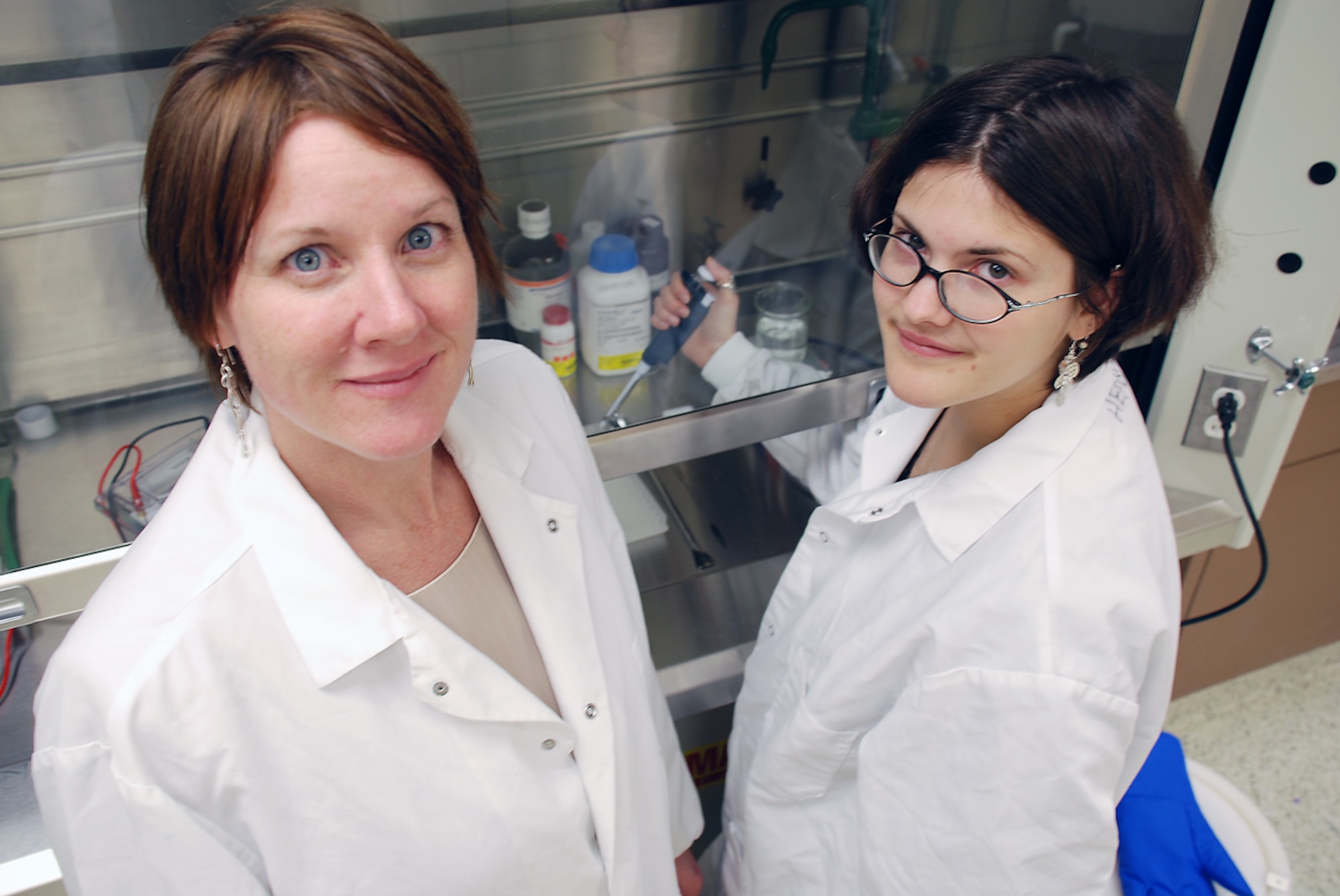 WRIGHT-PATTERSON AIR FORCE BASE, Ohio - Dr. Catherine Harrison (left) and research assistant Amy Huiet demonstrate the Western Blot laboratory technique used to quantify the level of a certain protein in a sample, which helps researchers to determine the effects of the environment on the complexity of the brain. Dr. Harrison is developing neurorehabilitation methods for traumatic brain injury patients. (Air Force photo by Chris Gulliford AFRL/HE)