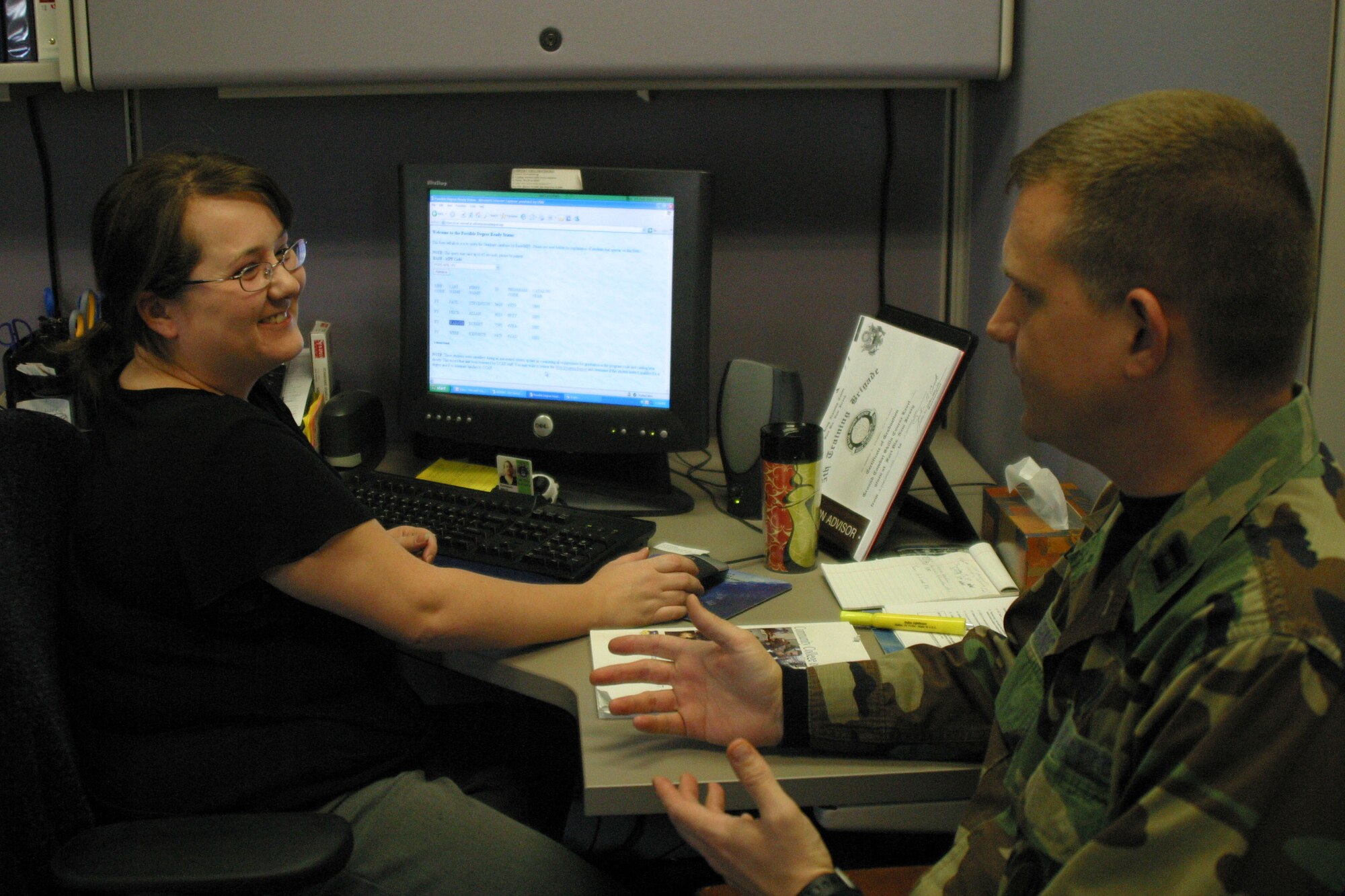 Capt. Michael Edging speaks to Education Advisor Amy Rodriguez about Pope education opportunities