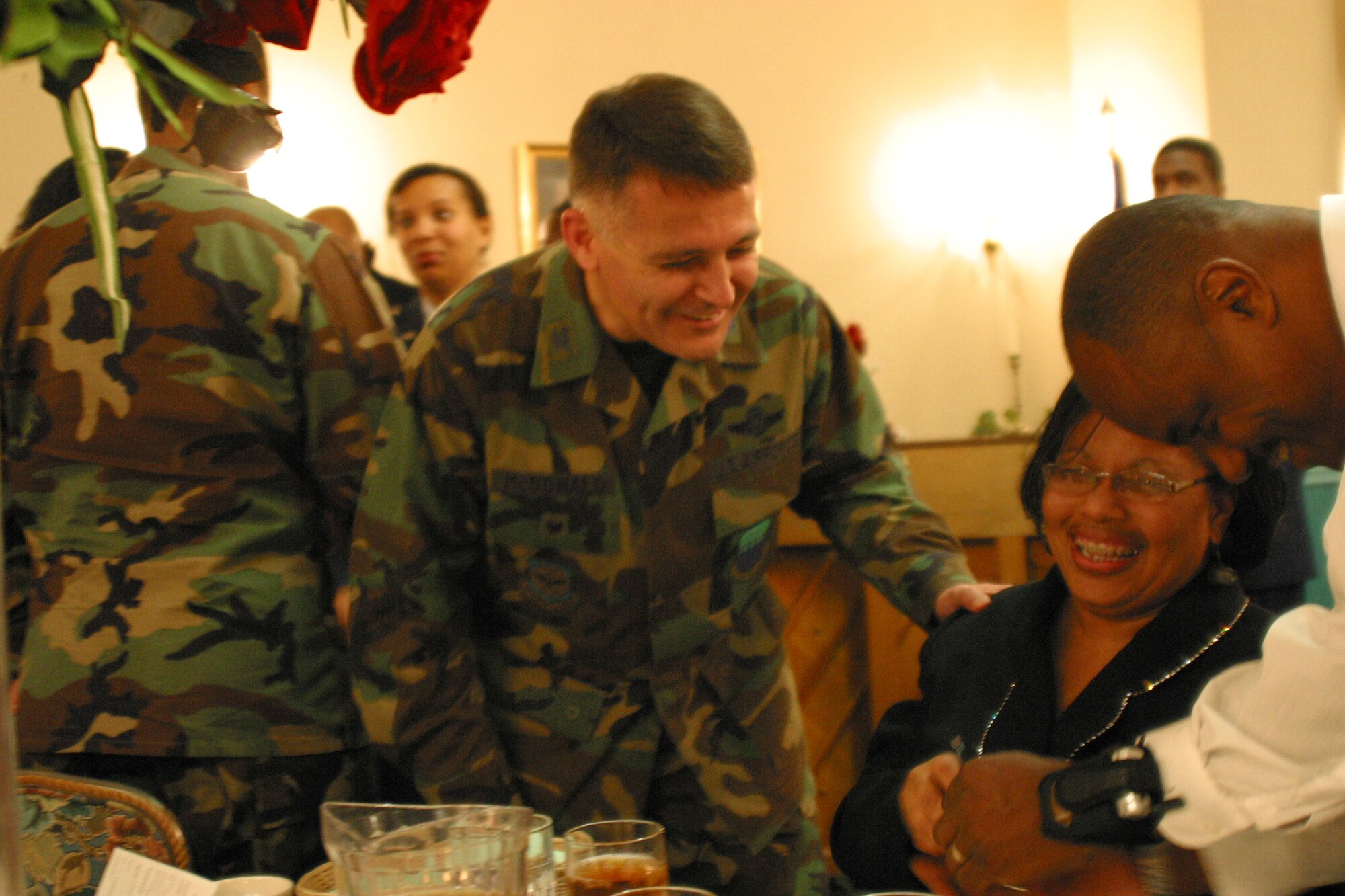 Col. John McDonald, 43rd Airlift Wing Vice Commander, applauds Natalie Boykin, 43rd Services Squadron, for her continuous volunteer efforts with the African American Heritage Committee at the committee's luncheon Tuesday.