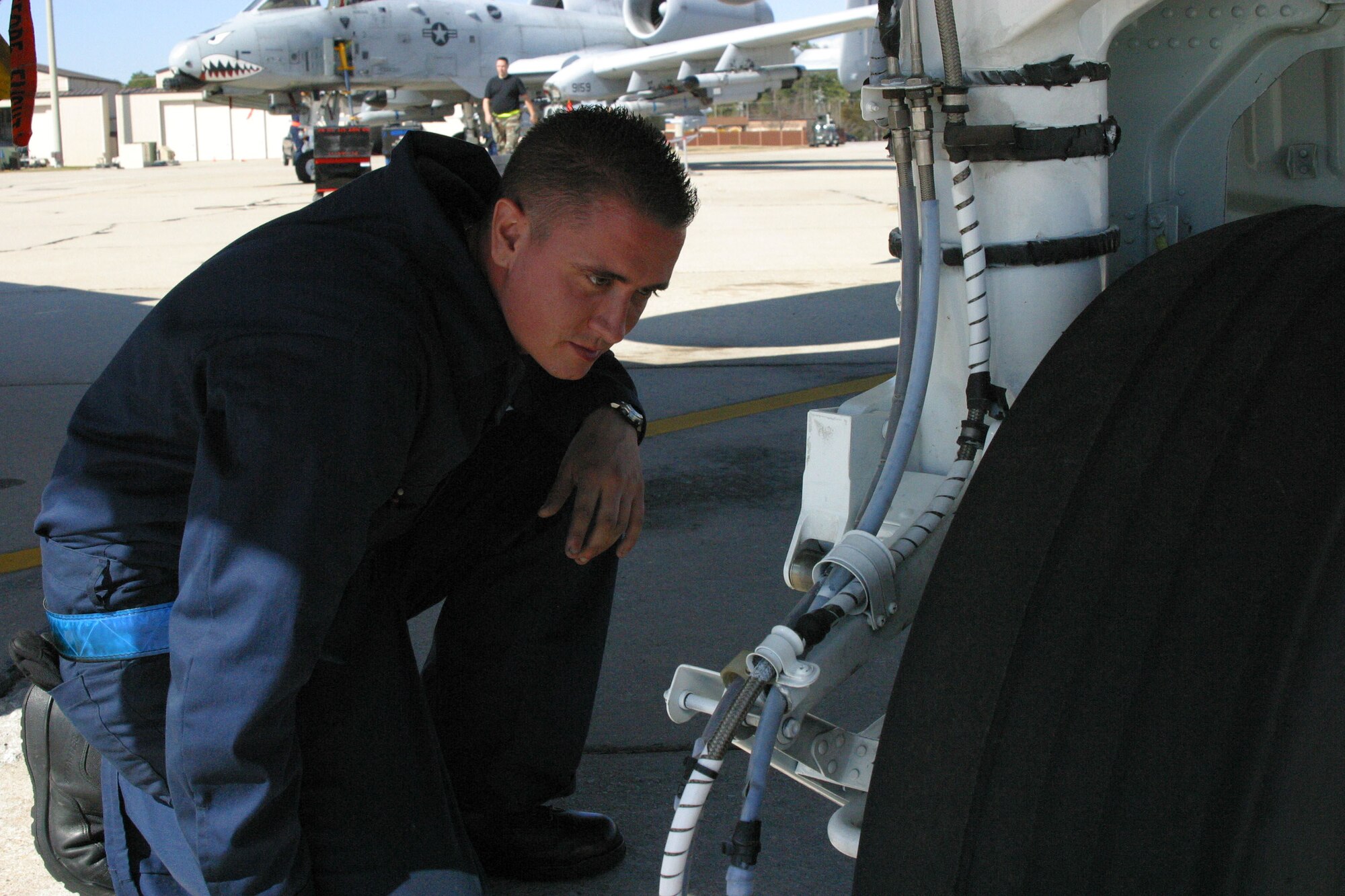 A-10 Assistant Crew Chief Airman 1st Class Edward Metcalf, 23rd Aircraft Maintenance Squadron, checks an A-10 tire during routine inspection. 
