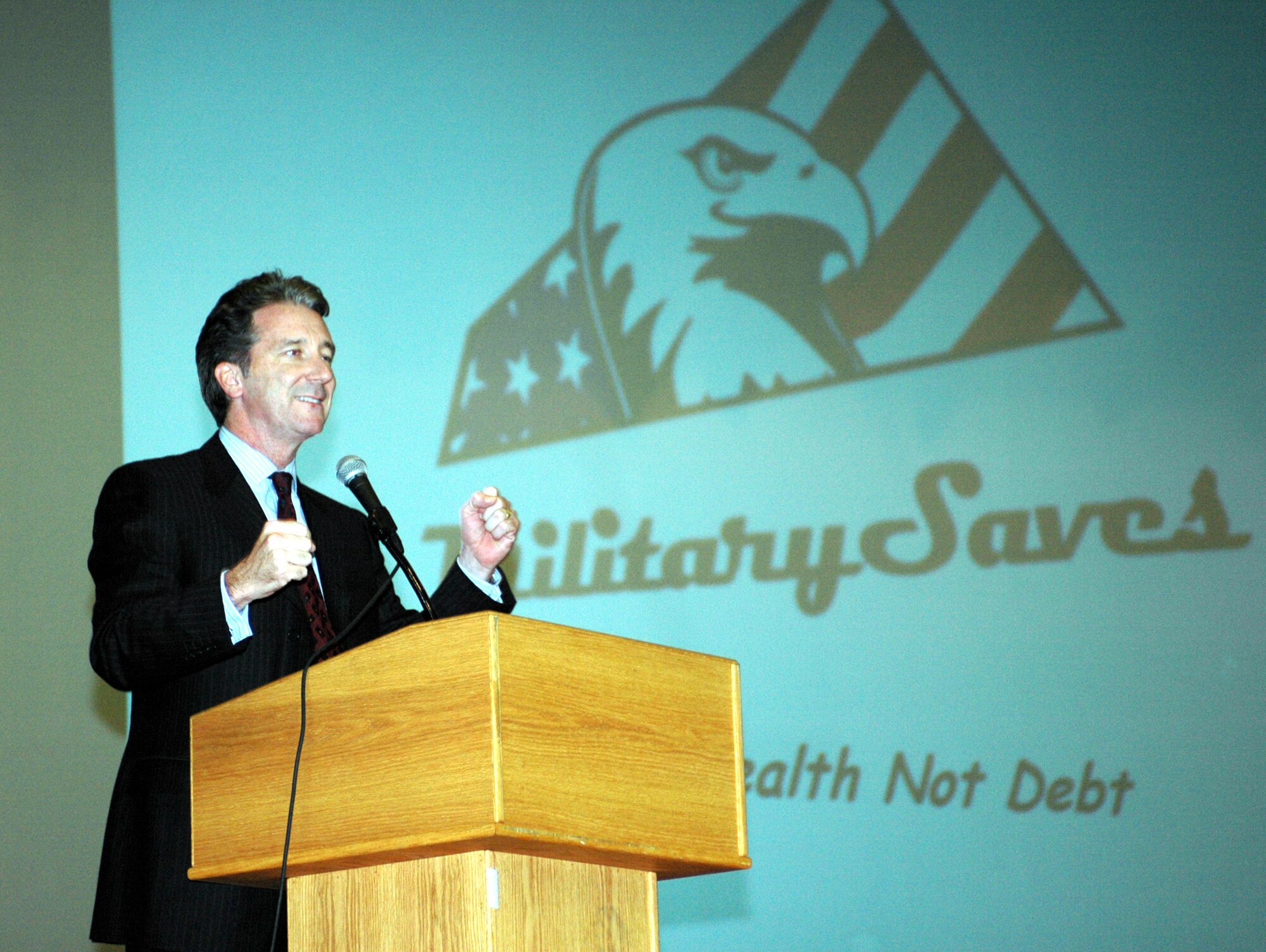 Mr. Kelly Brothers, News 10 business reporter, speaks to Team Travis members Feb. 23 as part of Travis' Military Saves campaign. Mr. Brothers spoke on the importance of saving money and acquiring wealth instead of debt. The Military Saves campaign began Feb. 23 and ends March 2. (U.S. Air Force photo by Tech. Sgt. Donald Osborn)