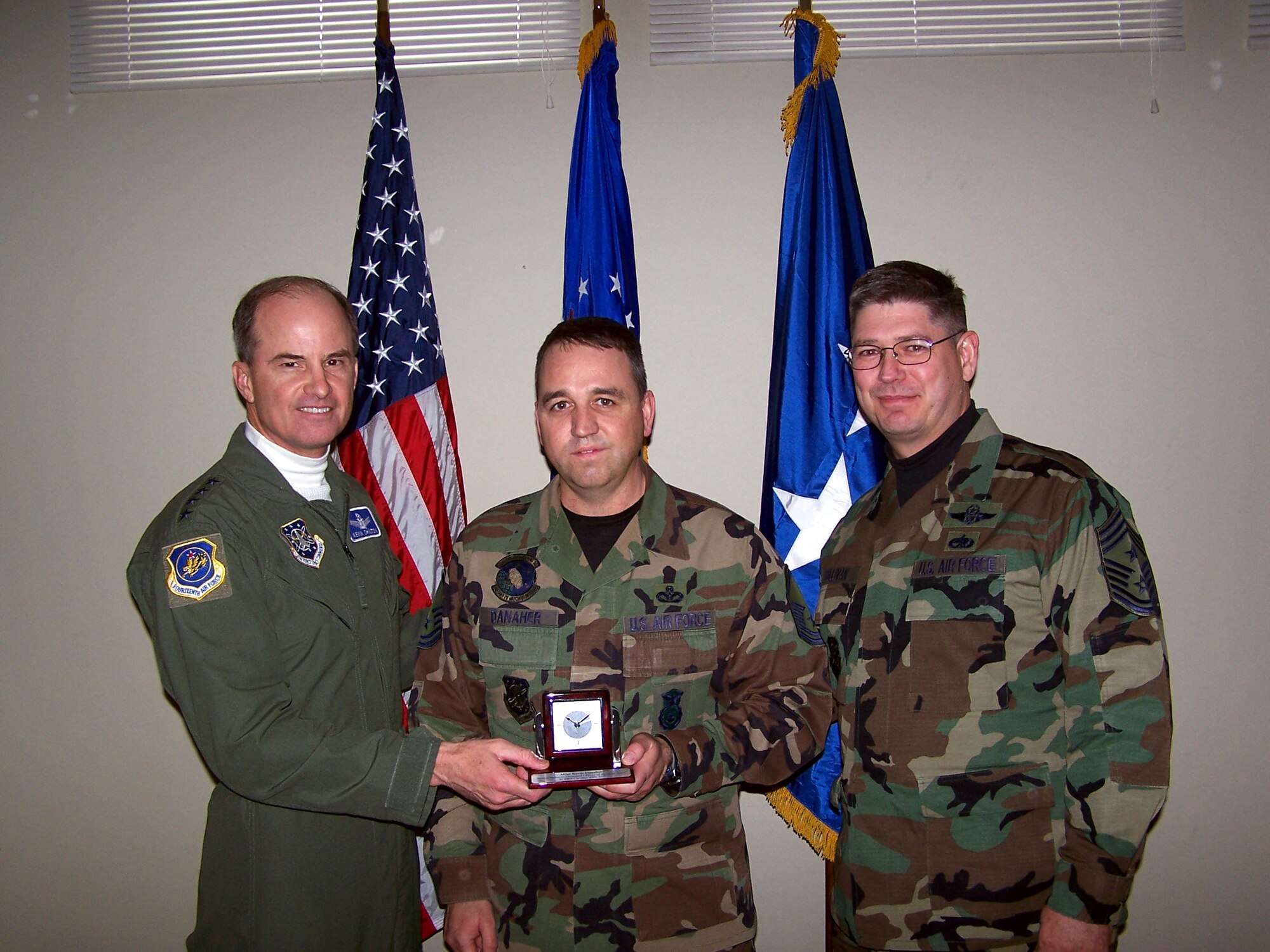 Gen. Kevin P. Chilton and Command Chief Master Sgt. Michael T. Sullivan present Master Sgt. Kevin Danaher, chief of Security Forces, with the Senior NCO of the Year award for the 10th Space Warning Squadron. (U.S. Air Force photo)
