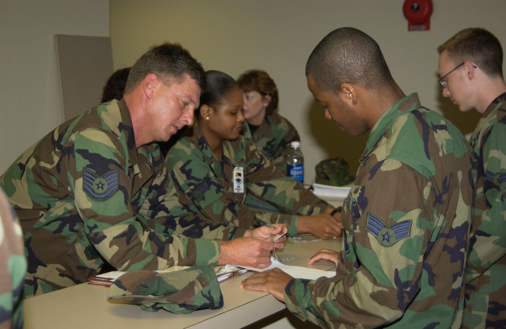 Tech. Sgt. David Wilder, 325th Mission Support Squadron base training manager, reviews an Airman’s training folder in a mass deployment line during the Operational Readiness Inspection in 2005.

