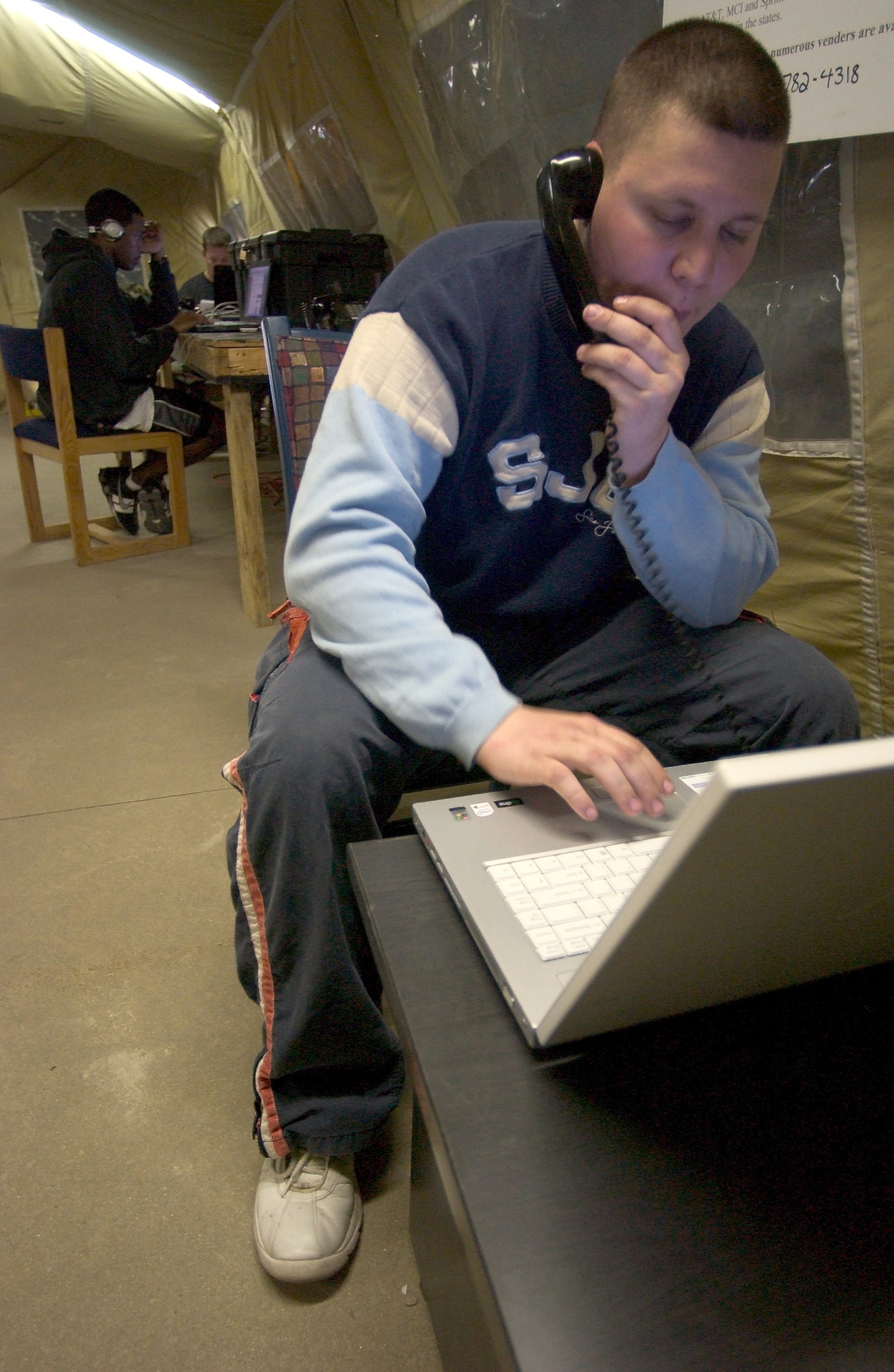 KUNSAN AIR BASE, Republic of Korea Feb. 26, 2007 -- Senior Airman Steven Utter, 9th EFS, stays in touch with loved ones back in the US with high-speed internet and telephone access provided to the more than 300 deployed Airmen. (Air Force Photo/Senior Airman Barry Loo)
