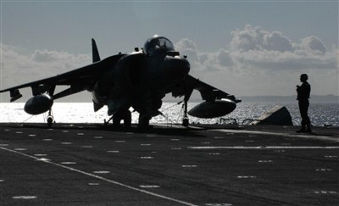 Aviation personnel perform maintenance on the engines of an AV-8B Harrier on board amphibious assault ship USS Essex in the Pacific Ocean, Feb. 26, 2007. Essex is the Navy's only forward deployed multi-purpose amphibious assault ship and is the flagship for the Essex Amphibious Readiness Group operating from Sasebo, Japan. 