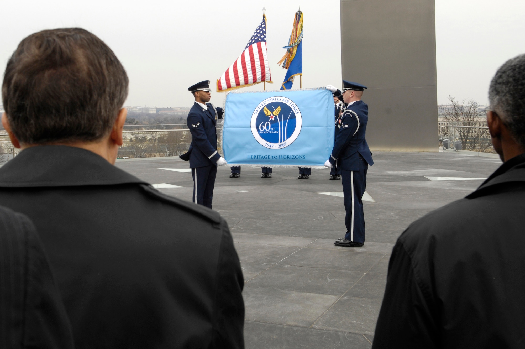 Members of the U.S. Air Force Honor Guard display the Air Force's 60th Aniversary flag during a ceremony at the Air Force Memorial March 1 in Arlington, Va.  The flag will fly at the memorial until the service's 60th birthday Sept. 18. (U.S. Air Force Photo/Senior Airman Daniel R. DeCook)