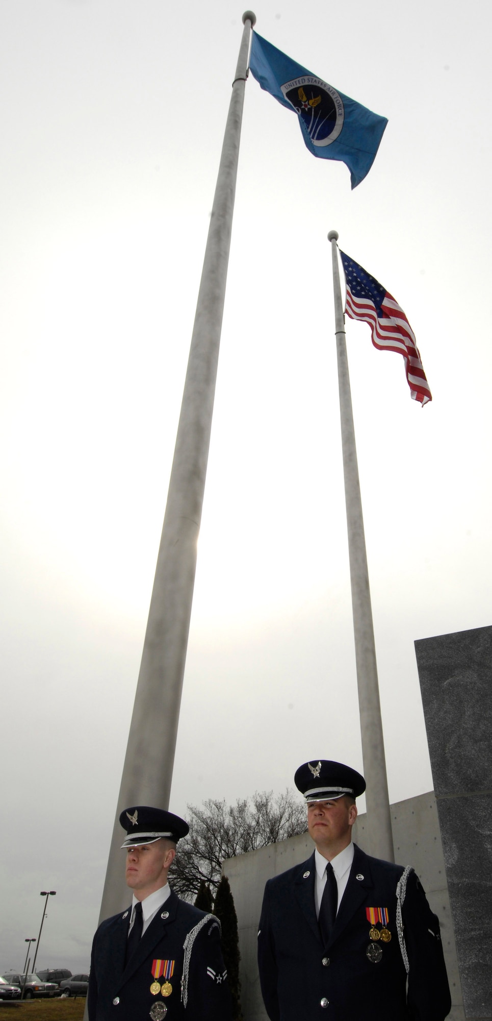 Airman 1st Class Donald Meissner (left) and Airman Steven Lowery stand at attention after raising the Air Force's 60th Anniversary flag March 1 at the Air Force Memorial in Arlington, Va.  The flag will fly at the memorial until the Air Force's 60th birthday on Sep 18.  The Airmen are Air Force Honor Guard ceremonial guardsmen.  (U.S. Air Force photo/Senior Airman Daniel R. DeCook)