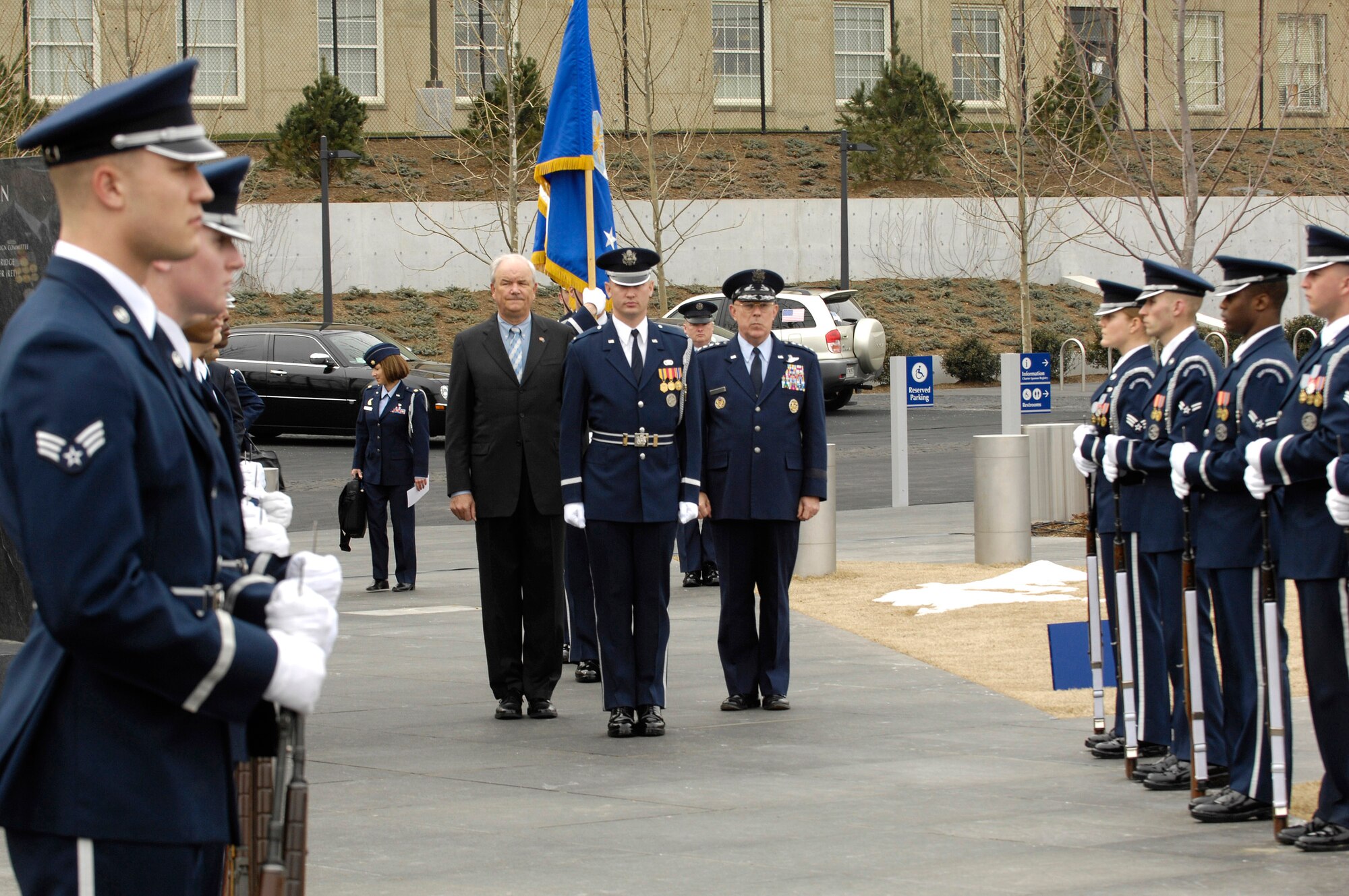 Secretary of the Air Force Michael W. Wynne and Air Force Chief of Staff Gen. T. Michael Moseley are escorted to the base of the Air Force Memorial in Arlington, Va., March 1 for a ceremony in which the Air Force's 60th Anniversary flag was unveiled.  The flag will fly at the Air Force memorial until the Air Force's 60th birthday on Sep 18.  (U.S. Air Force photo/Senior Airman Daniel R. DeCook)