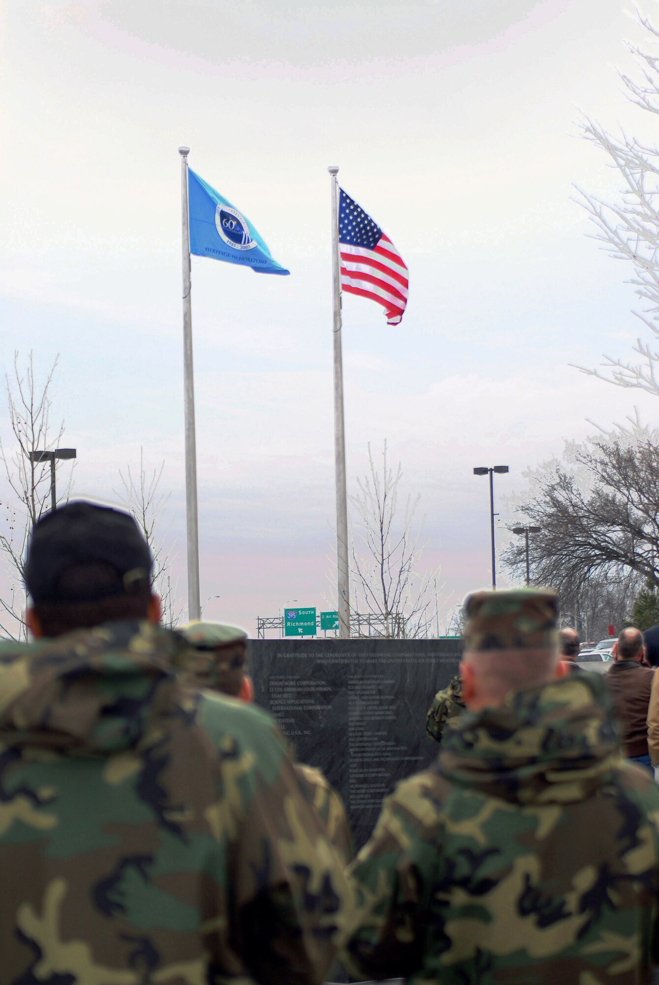 The newly unveiled Air Force 60th Anniversary flag is drawn up the flagpole for the first time March 1 at the Air Force Memorial in Arlington, Va.  The ceremony was attended by Chief of Staff of the Air Force Gen. T. Michael Moseley and Secretary of the Air Force Michael W. Wynn. (U.S. Air Force photo/SSgt. Madelyn Waychoff)