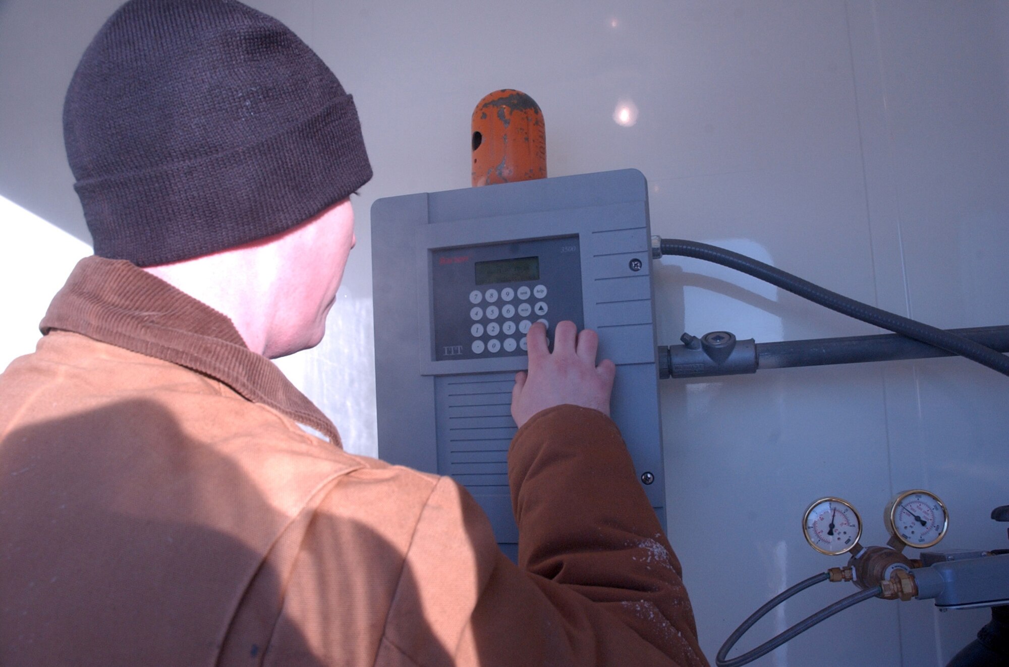 EIELSON AIR FORCE, Alaska -- Staff Sgt. Kyle Evans, 354th Logistics Squadron, checks an automatic tank gauging system to verify how much fuel is in the bulk storage fuel tanks. The fuels team manages the fourth largest fuel storage area in the Air Force. (U.S. Air Force photo by Senior Airman Justin Weaver)