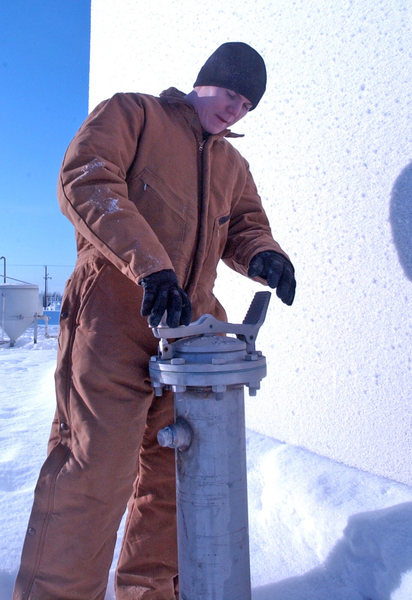 EIELSON AIR FORCE, Alaska -- Staff Sgt. Kyle Evans, 354th Logistics Squadron, inspecs a "Tell Tale" pipe used to detect any leaks under a bulk fuels storage tank. Working at the farthest-north Air Force base in the world - located 150 miles south of the Arctic Circle - presents these Airmen with challenges some have never faced before. (U.S. Air Force photo by Senior Airman Justin Weaver)