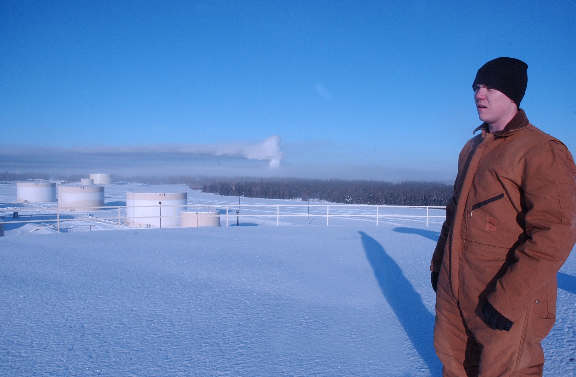 EIELSON AIR FORCE, Alaska -- Staff Sgt. Kyle Evans, 354th Logistics Squadron, visually inspects the top of a bulk fuels storage tank. Despite 42 below zero temperatures, the fuels team braves the arctic cold in order to ensure the integrity of the bulk fuels systems. (U.S. Air Force photo by Senior Airman Justin Weaver)