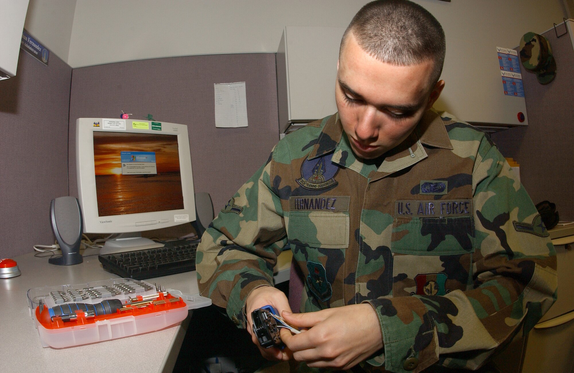 Client support administrator, Airman Jonathon Fernandez, 392 Training Squadron, strips some wire in order to make CAT 5 cables on Feb. 21 at Vandenberg.  CAT 5 cables are used to connect workstations to the 30th Communications Squadron's server so they can have access to the network.  (U.S. Air Force photo by Airman 1st Class Nicole Roberts)
