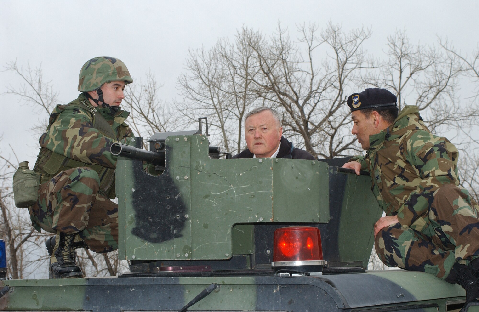 Security Forces Group Commander Col. Steve Asher, right, and Airman 1st Class David McComb, discuss security operations with retired Gen. Eugene Habiger during a demonstration for him Feb. 22 at Camp Grizzly.