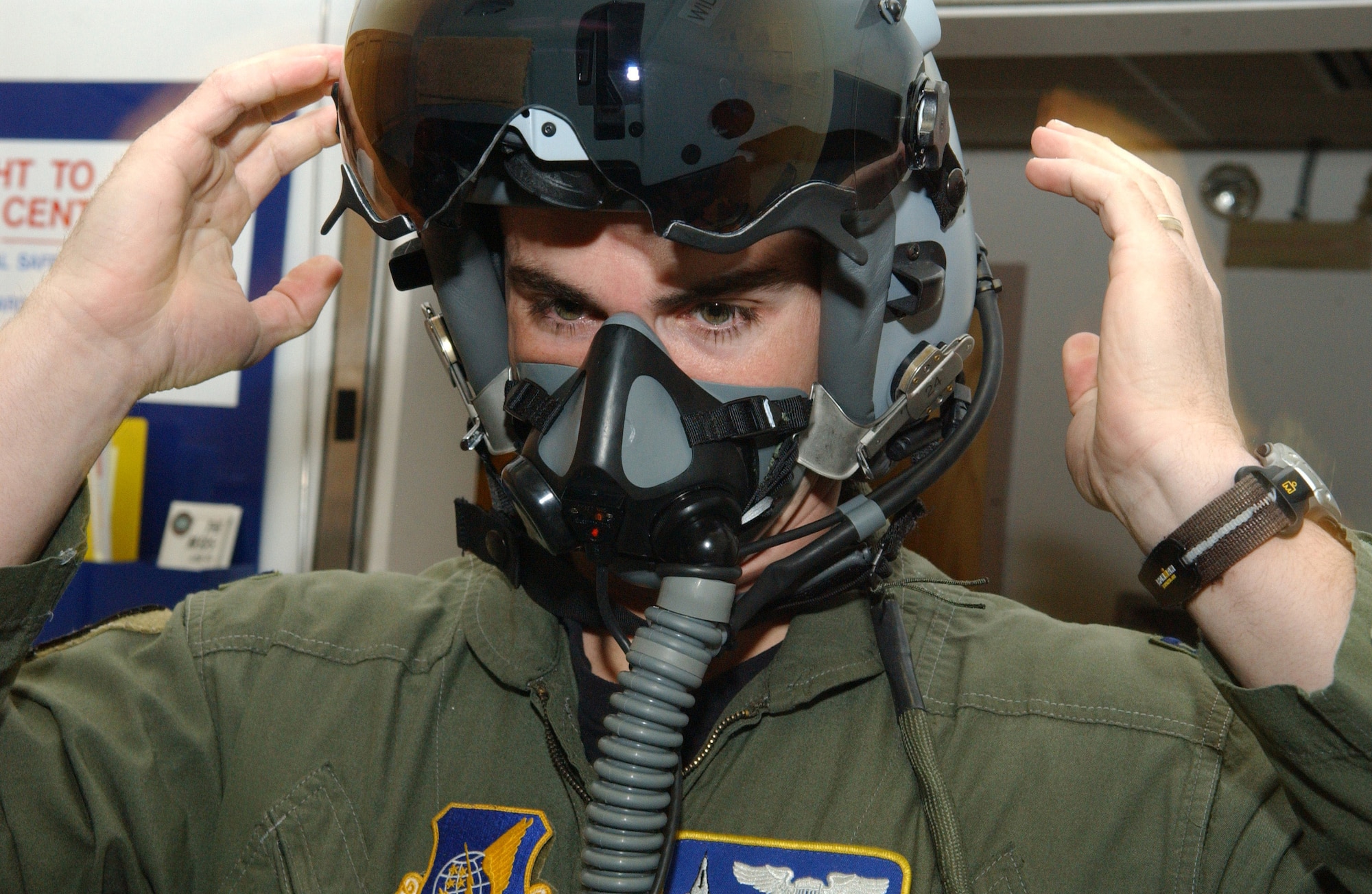 Capt. Jeremey Wimer tries on a newly issued fighter helmet while gearing up Feb. 21 at the 18th Fighter Squadron at Eielson Air Force Base, Alaska. The new helmet mounted queing system has targeting technology that projects holographic data on the inside right of the visor in the form of a container, or que and allows pilots to continually survey and distinguish between friendly and enemy air and ground targets. Captain Wimer is an F-16 Fighting Falcon pilot. (U.S. Air Force photo/Airman 1st Class Christopher Griffin)